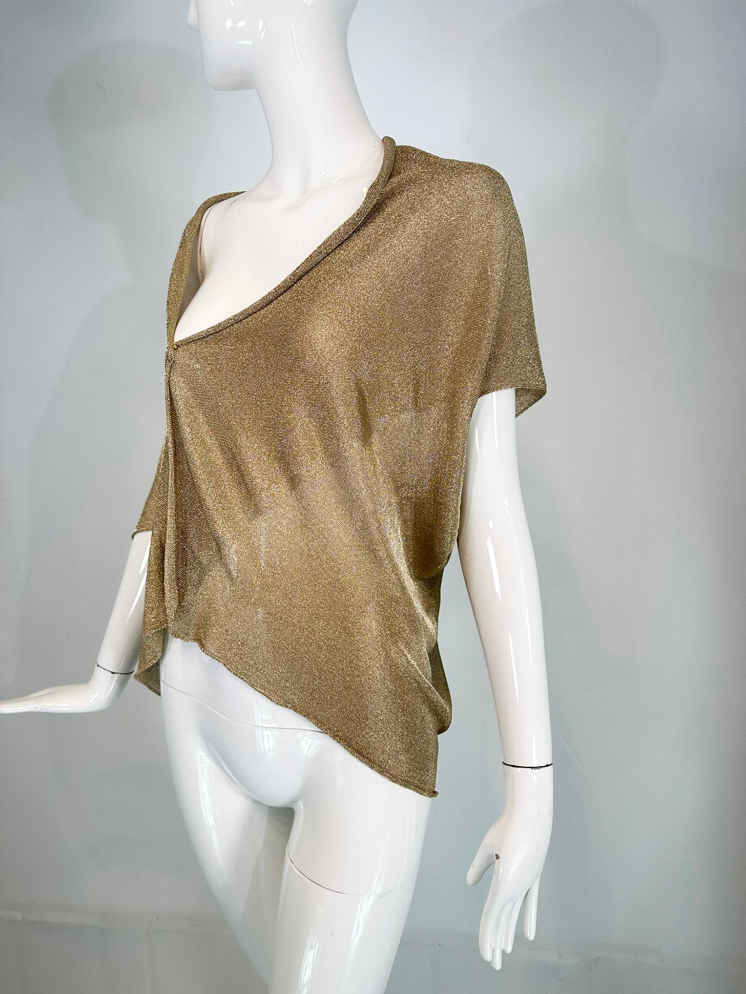 Alberta Ferretti gold metallic knit asymmetrical, cropped, draped, sleeveless, layering shrug. New with tags, this versatile piece is a perfect add to any outfit from evening to day wear. Unworn with tags. 
In excellent wearable condition.  All our