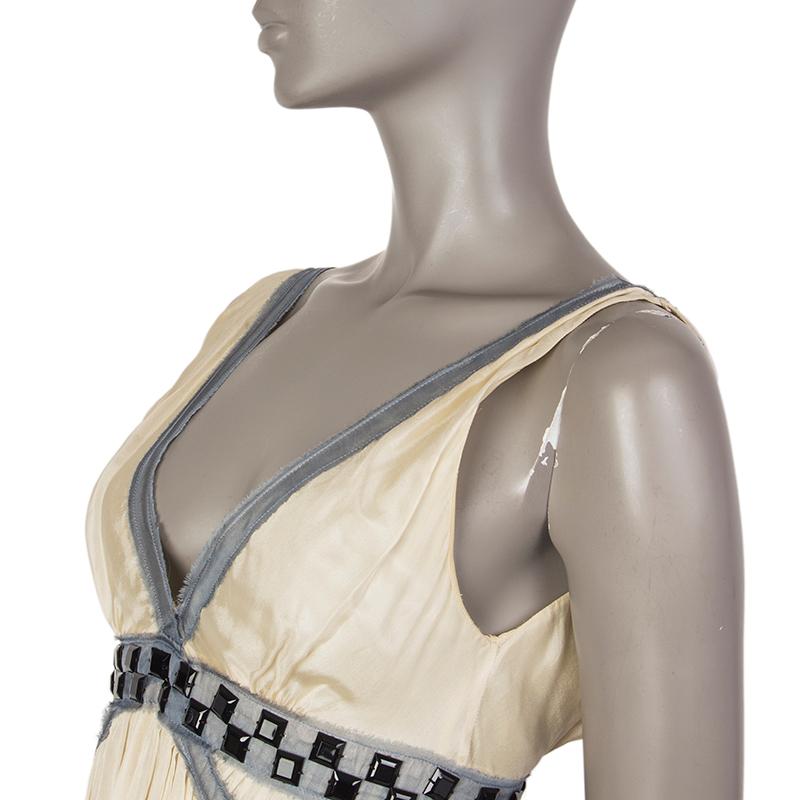 100% authentic Alberta Ferretti babydoll dress in cream, grey, and black silk (100%). With large square beads under the chest, gathered pleats from the waist, and fray trims. Closes with small concealed snaps on the side. Lined in light vanilla