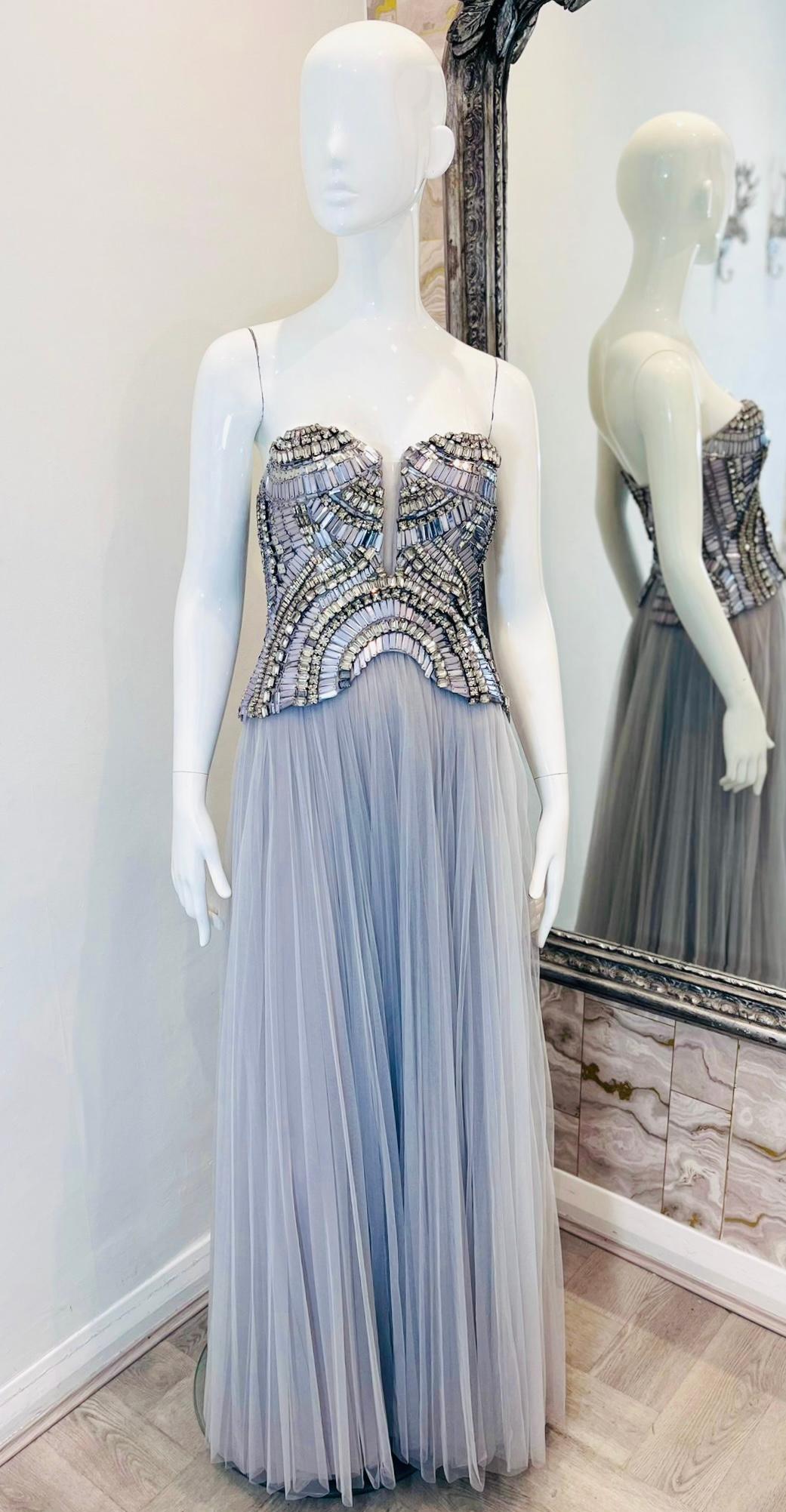 Alberta Ferretti Limited Edition Crystal & Bead Tulle Gown

Light slate grey strapless gown designed with crystal and bead embroidered corset.

Detailed with sweetheart neckline and deep V-Cut with a sheer insert.

Featuring long, tulle plisse skirt