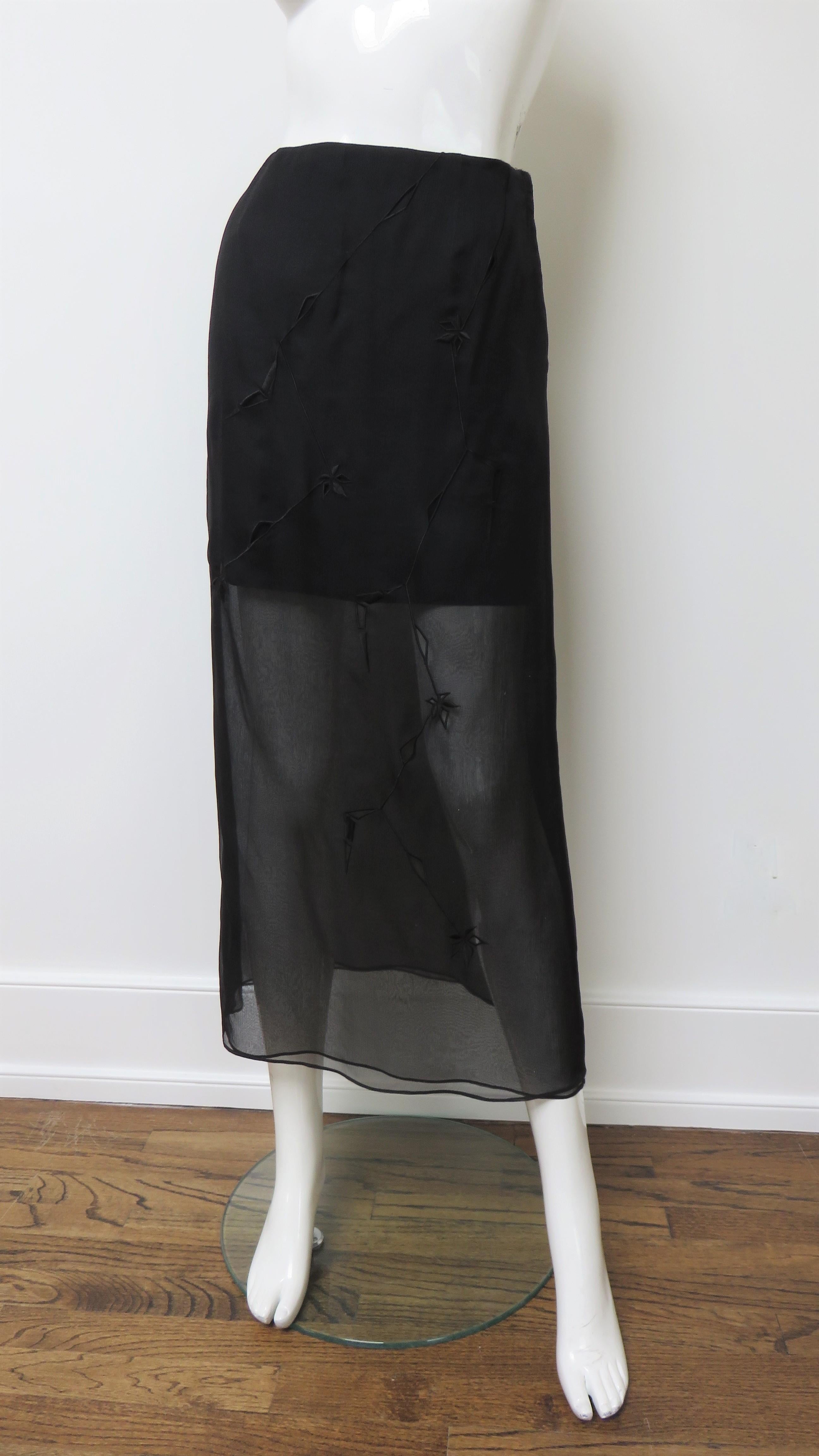 A gorgeous semi sheer silk skirt from Alberta Ferretti.  It is comprised of 2 layers of sheer silk with embroidered cut outs over a short silk underskirt.  It has a side seam zipper, the back does not have embroidery or cut outs.
Fits sizes Extra