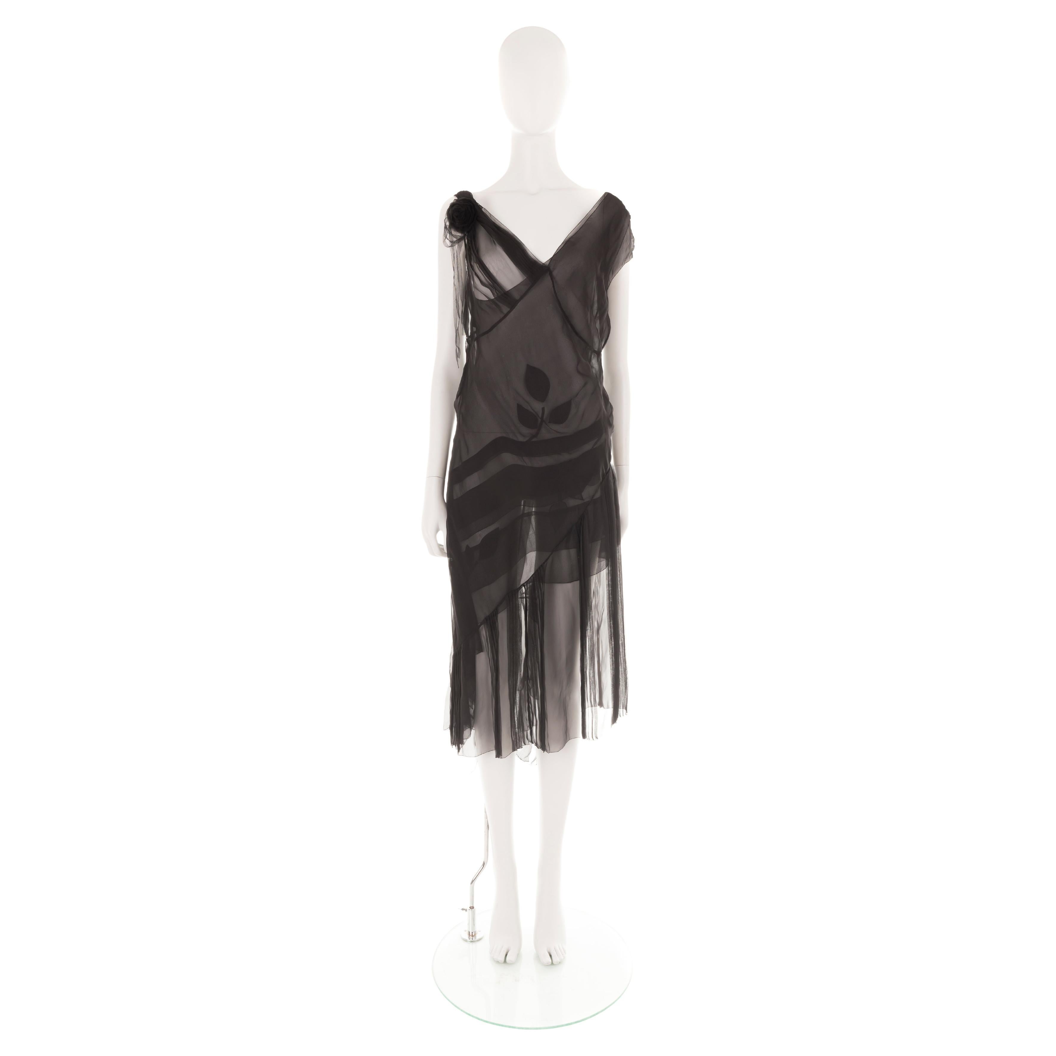 - 2 pieces dress (+ additional black under slip dress, not pictured)
- Sheer black silk chiffon layers
- One shoulder asymmetric underlayer with floral motif
- V-neck overlay with asymmetric pleated overskirt
- Black tulle rose appliqué