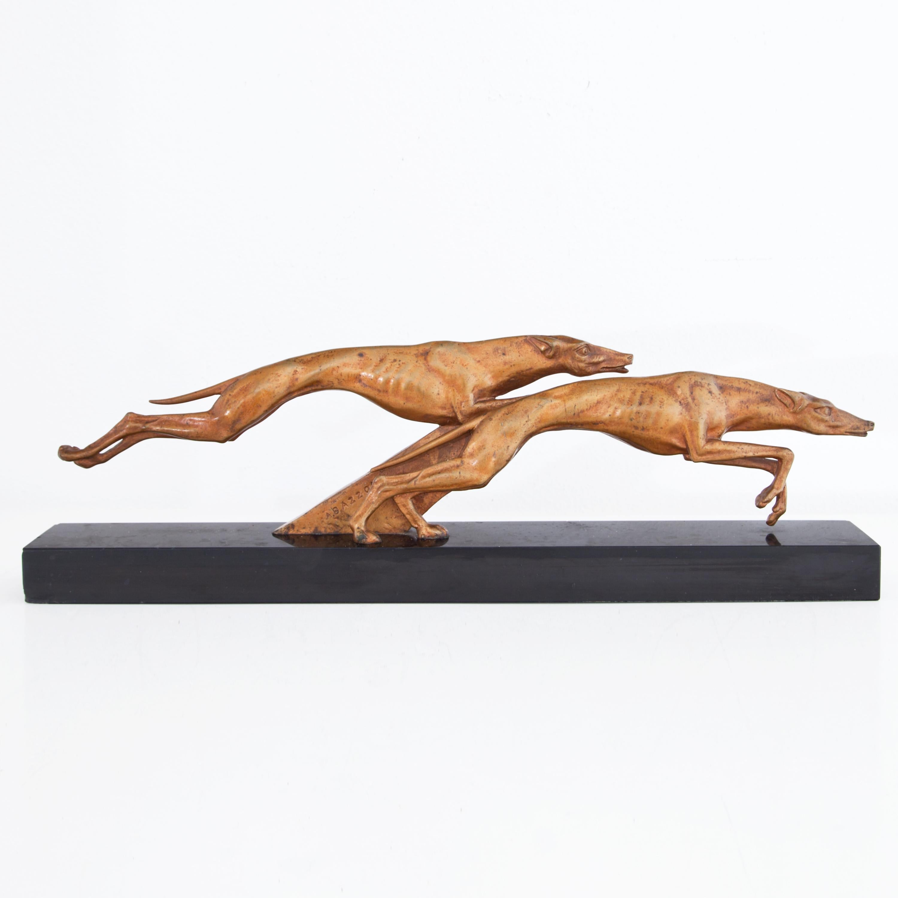 Bronze of two naturalistically modelled racing greyhounds on a black base. Signed A. Bazzoni.