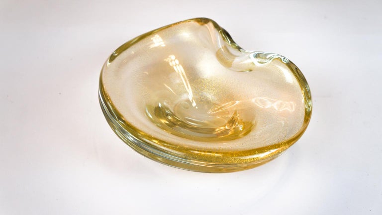 Beautiful Murano glass bowl colour crystal covered with gold leaf 24 carats. 
The process of venetian blown glass is completely performed by Murano artisans. 
Designed by the master Alberto Dona' in 1980

Touching the bowl you can feel the