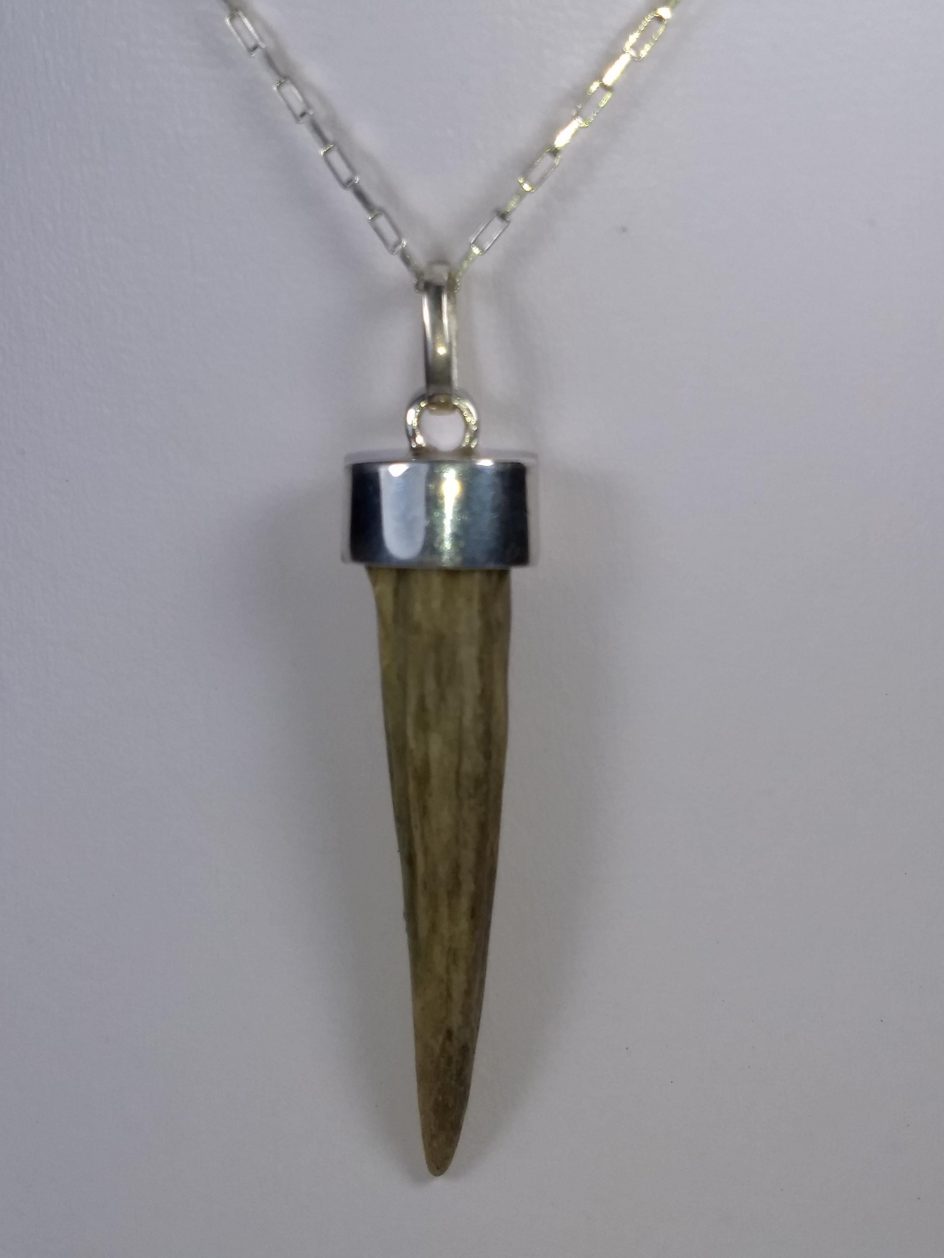 This Alberto Juan one of a kind necklace was handmade using a wild deer antler horn and sterling silver. The chain and findings used in this piece are sterling silver. Necklace measures 17.5