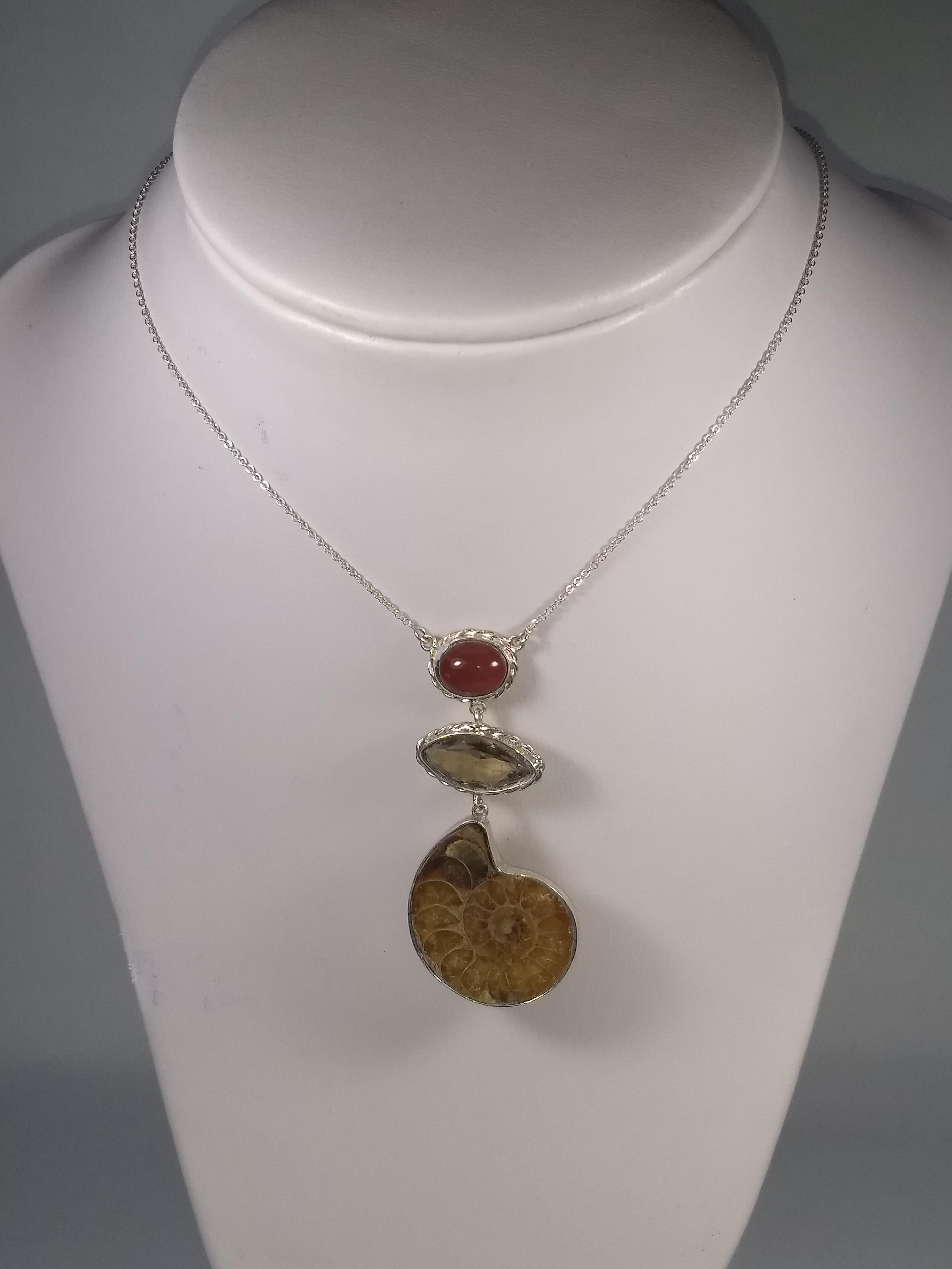 This Alberto Juan one of a kind necklace was handmade from sterling silver, Mexican fire opal (2.5 carats), marquise shaped smoky quartz (4.5 carats) , and ammonite. The chain and findings used in this piece are sterling silver. Necklace measures