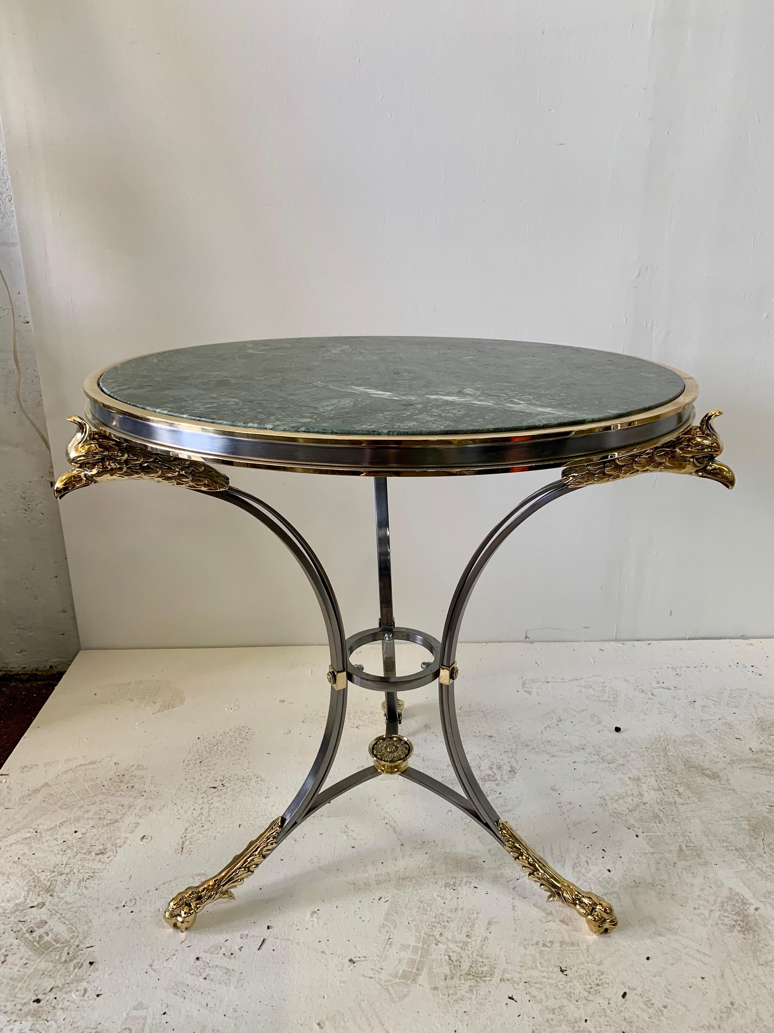 Neoclassical style Gueridon table with phoenix head and hoof motif in brass and steel with original green marble top, signed / Stamped, 1970s

   