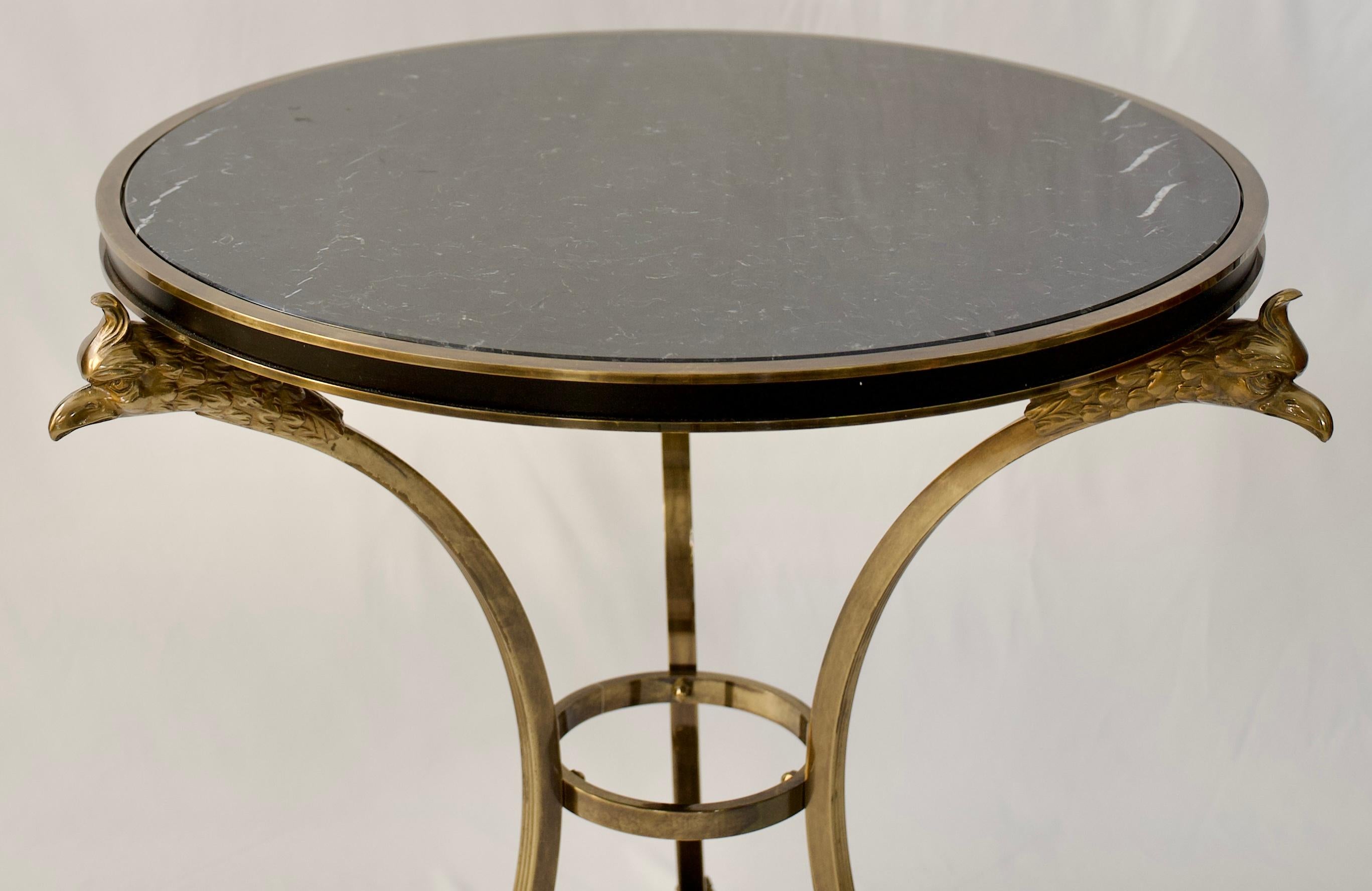 A very fine pair of Alberto Orlandi Neoclassical style Gueridon tables with phoenix head and hoof motifs in brass and steel with original black marble tops, circa 1970's.

These stylish black marble top side tables by Alberto Orlandi designed