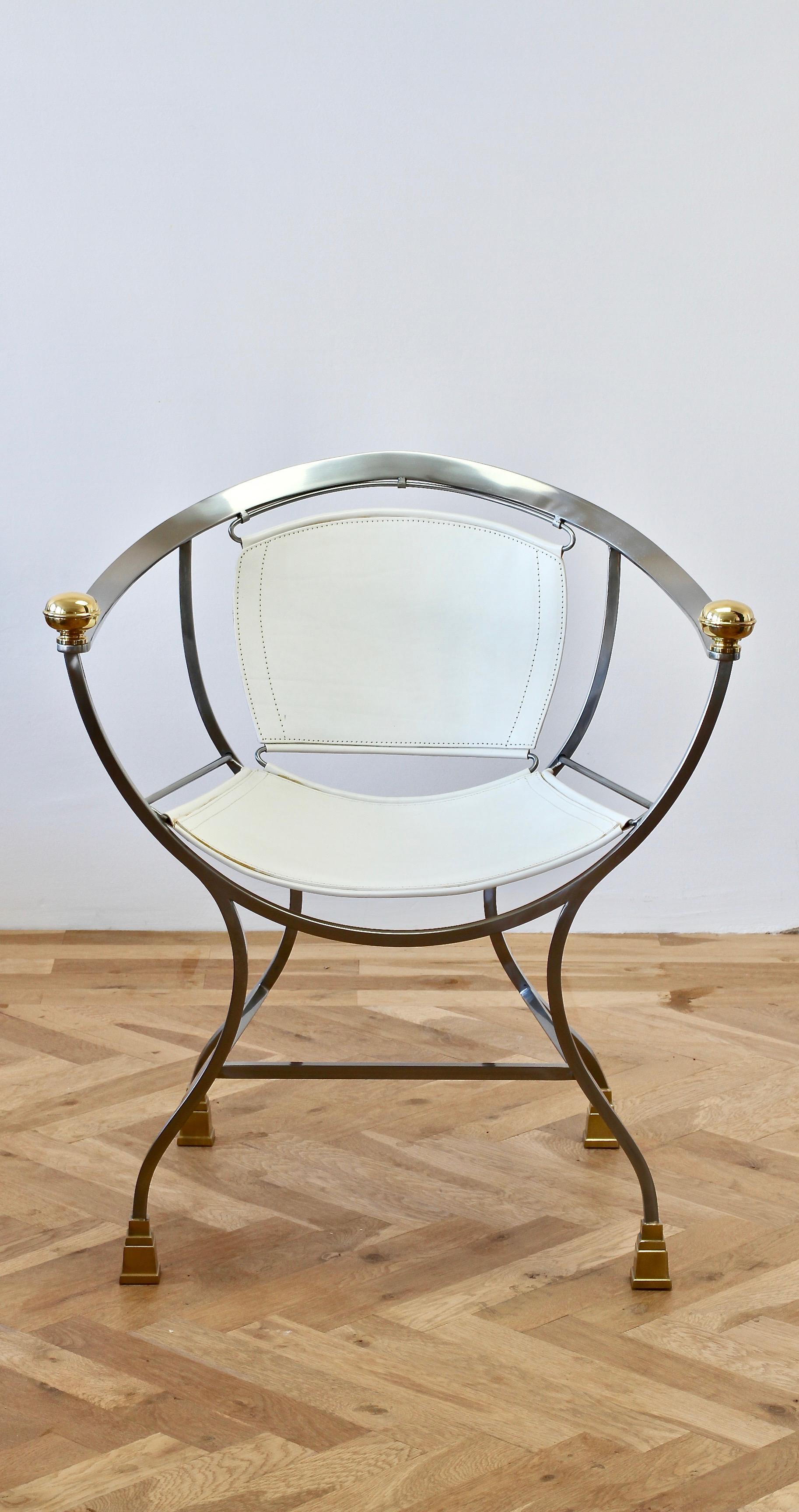 One of a set of four rare vintage 'Pompeii' armchairs or seats by Italian designer Alberto Orlandi, circa late 1970s-early 1980s. Made in Italy and featuring polished steel, solid cast brass feet and armrest details with white leather seat and