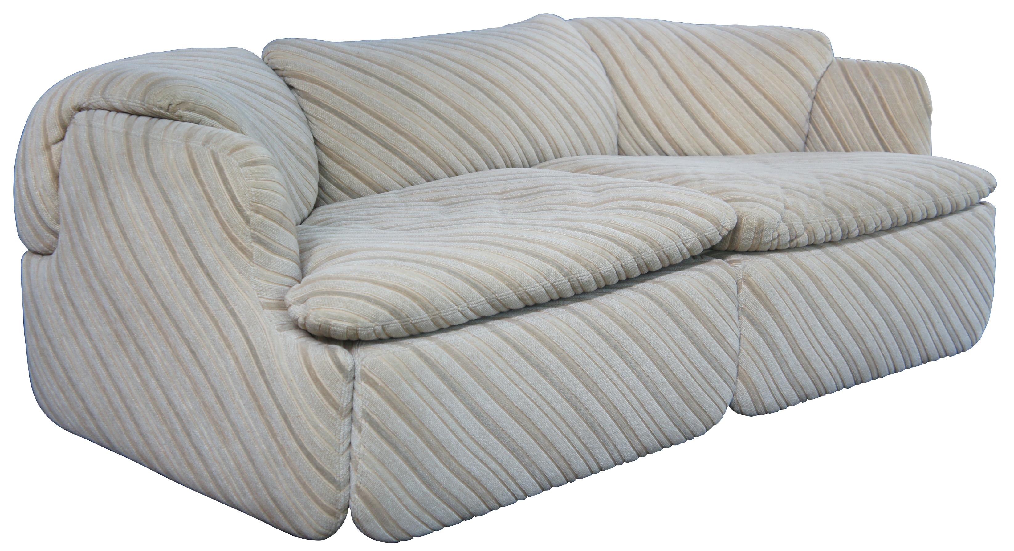 Iconic Fratelli Saporiti Italian Confidential lounge, library or club sofa / couch by Alberto Rosselli, circa 1970s. One of the first modular club chairs with a puzzle like cushion connection creating a pivotal look. 

Provenance : Jerome