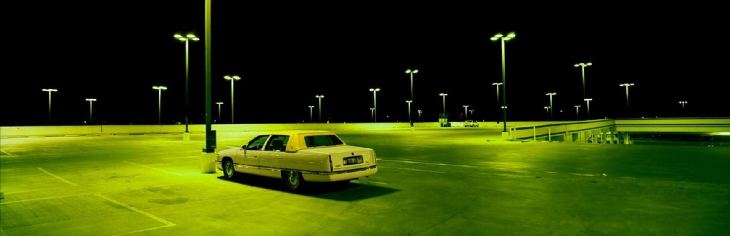 Albert Watson Still-Life Photograph - Cadillac in Parking Lot, Las Vegas - the car in the dark with lights in green