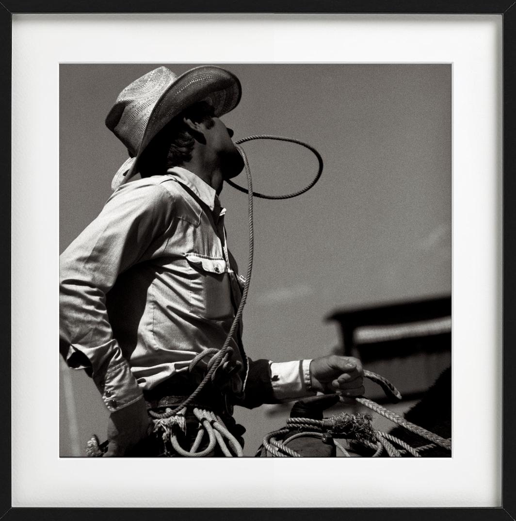 Black and White Portrait of a Cowboy at Calgary Rodeo holding his Rope between his teeth while riding, photographed by Albert Watson in 1979.

All prints are limited edition. Available in two sizes. High-end framing on request.

All prints are done