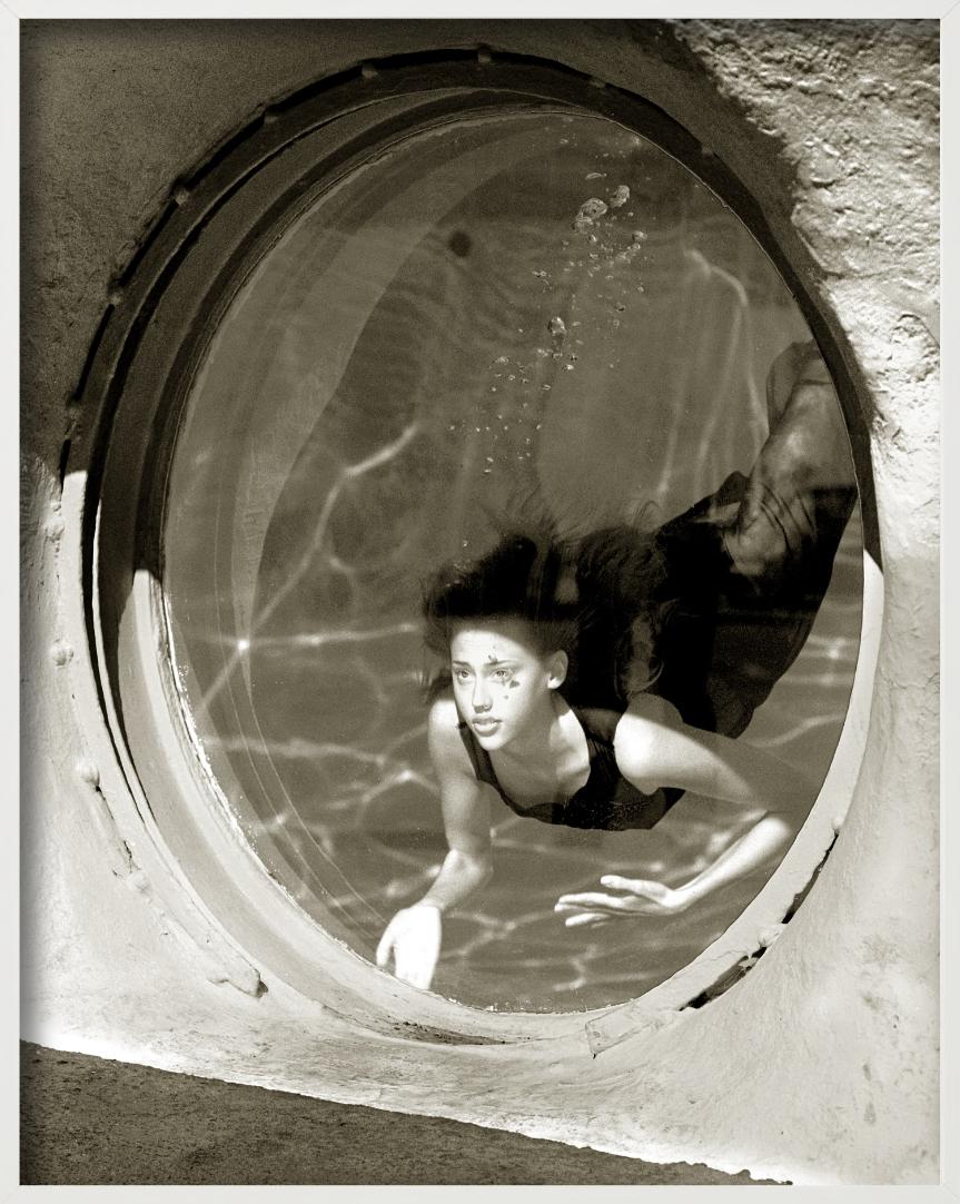 Model Estella Warren Diving in a Pool and looking out through a round Window, photographed by Albert Watson, 1998.

All prints are limited edition. Available in multiple sizes. High-end framing on request.

All prints are done and signed by the