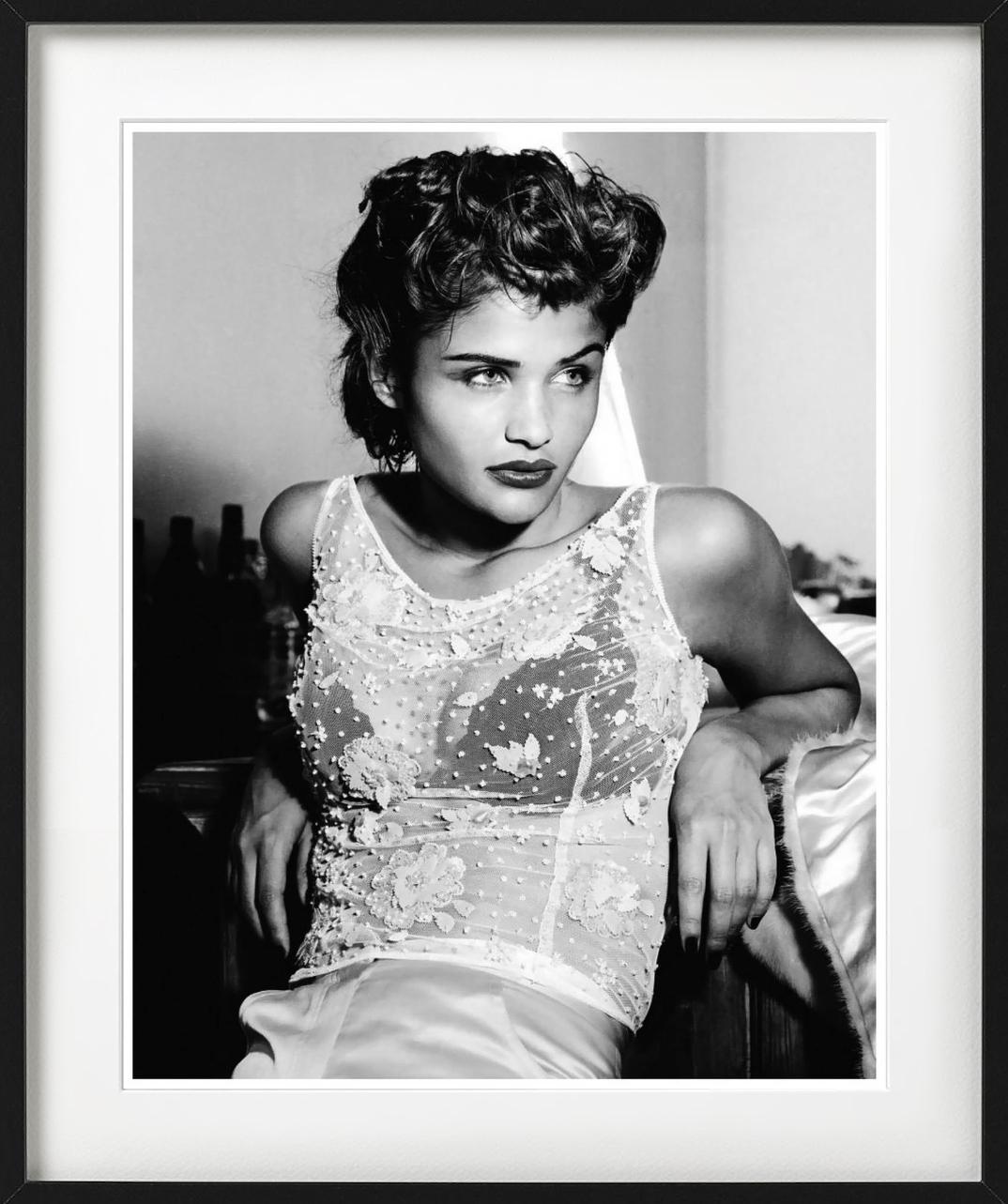 Black-and-white portrait of the famous supermodel Helena Christensen in a transparent lace blouse and 40s-style hair, photographed by Albert Watson in 1991.

All prints are limited edition. Available in multiple sizes. High-end framing on