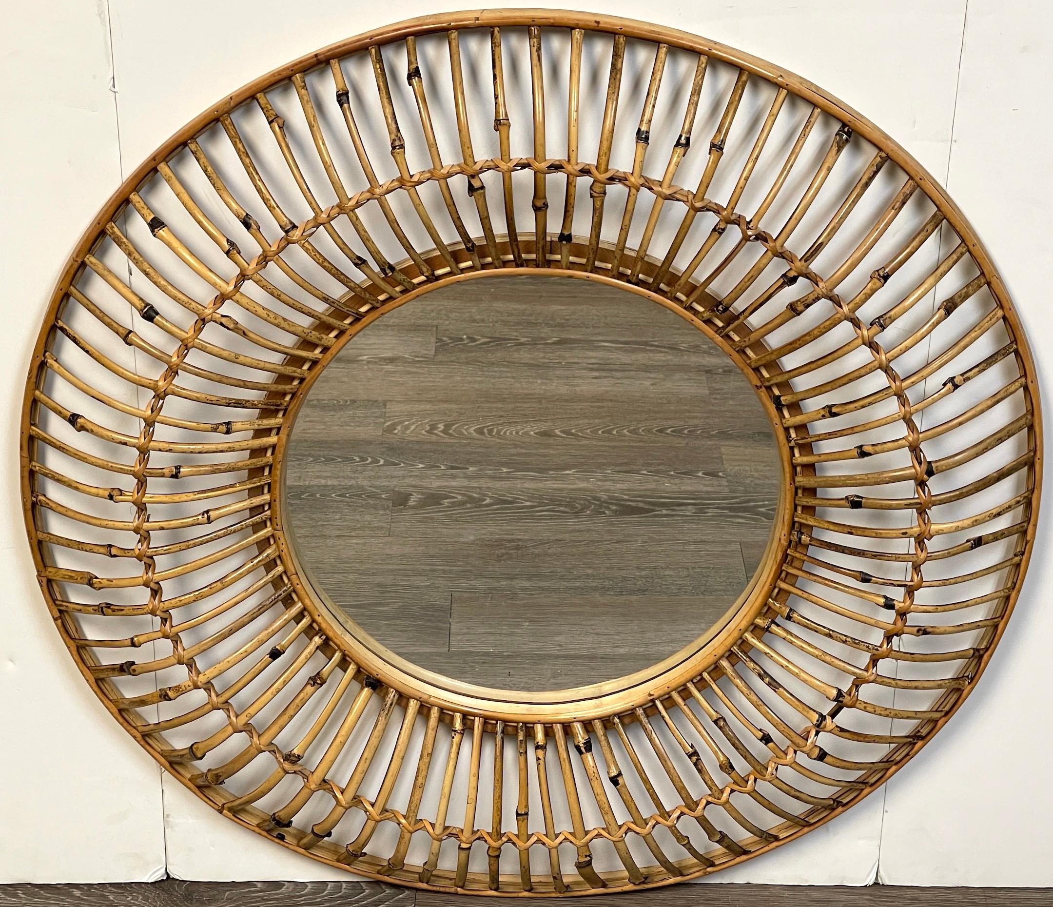 Albini style sunburst bamboo & rattan mirror
A fine example, well executed of a continuous surround of 3-inch high curved bamboo with appliqué double ribbon of woven reed and willow. Complete with a 15-Inch inset clear mirror. 

