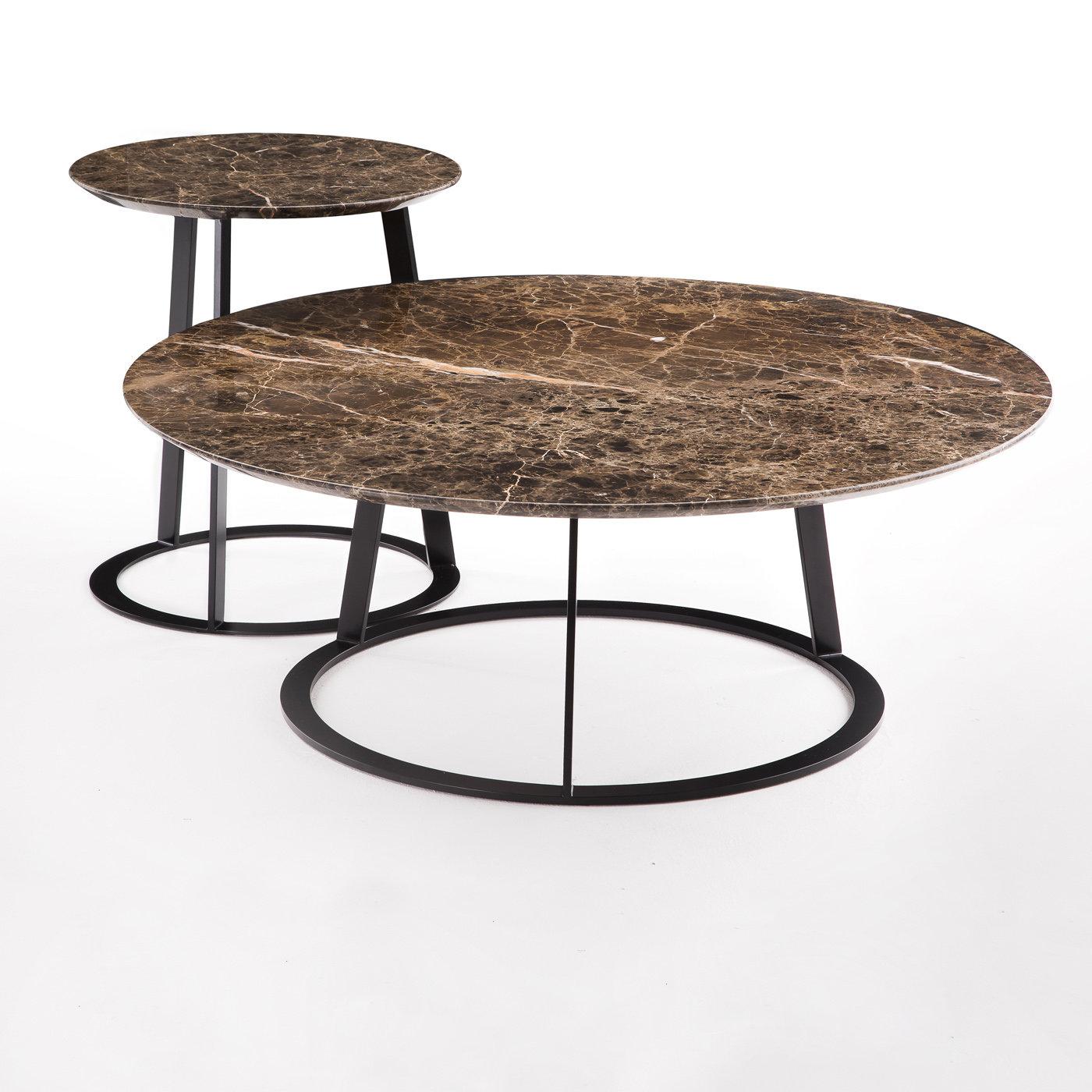 This coffee table was designed by Salvatore Indriolo following the success of his first Albino table introduced in 2010. A refined piece of functional decor, it features a round top made of Emperador dark marble resting on a robust black