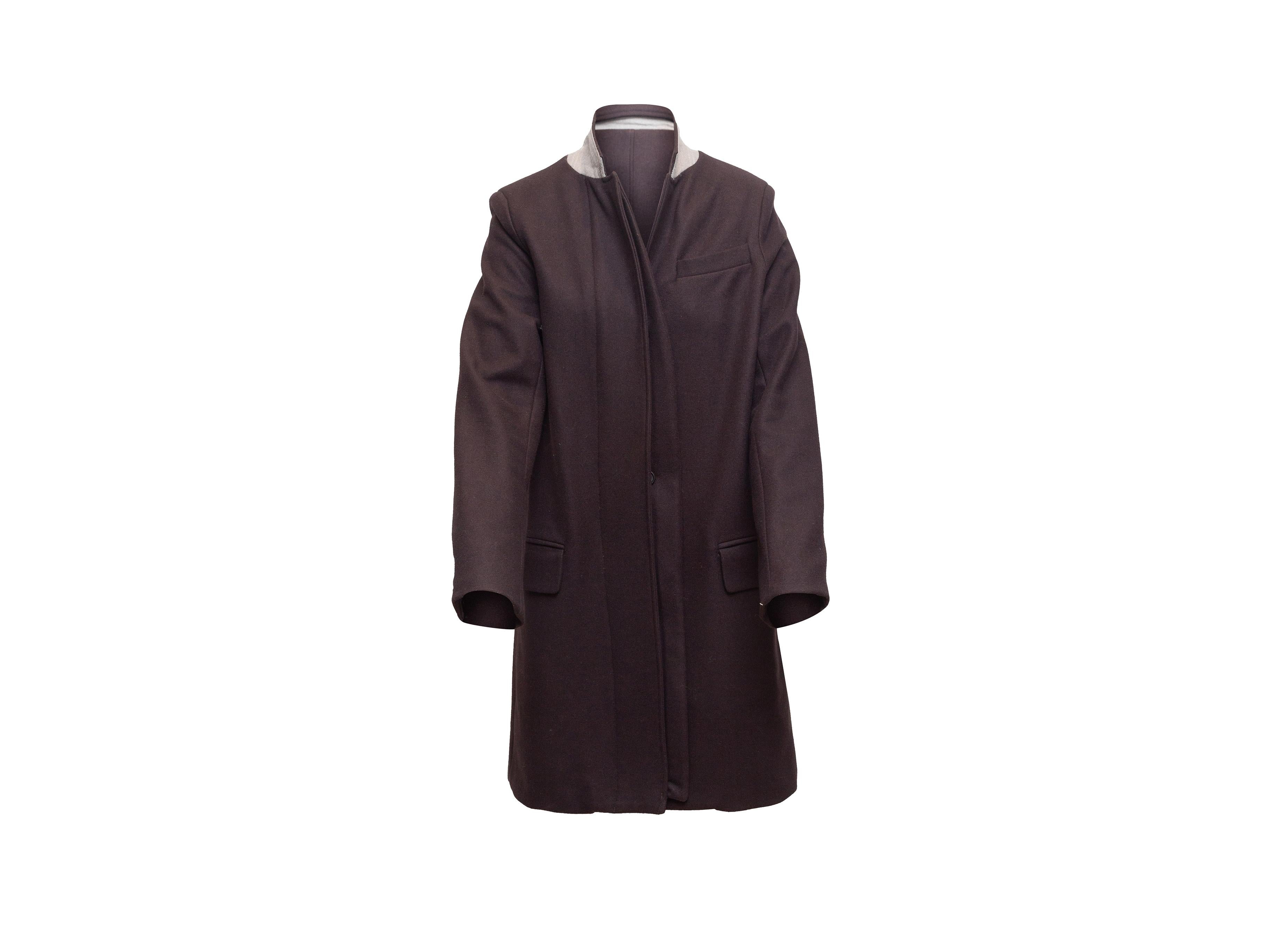 Product details: Dark purple long virgin wool coat by A.L.C. Shawl collar. Three pockets. Concealed button closures at front. 34
