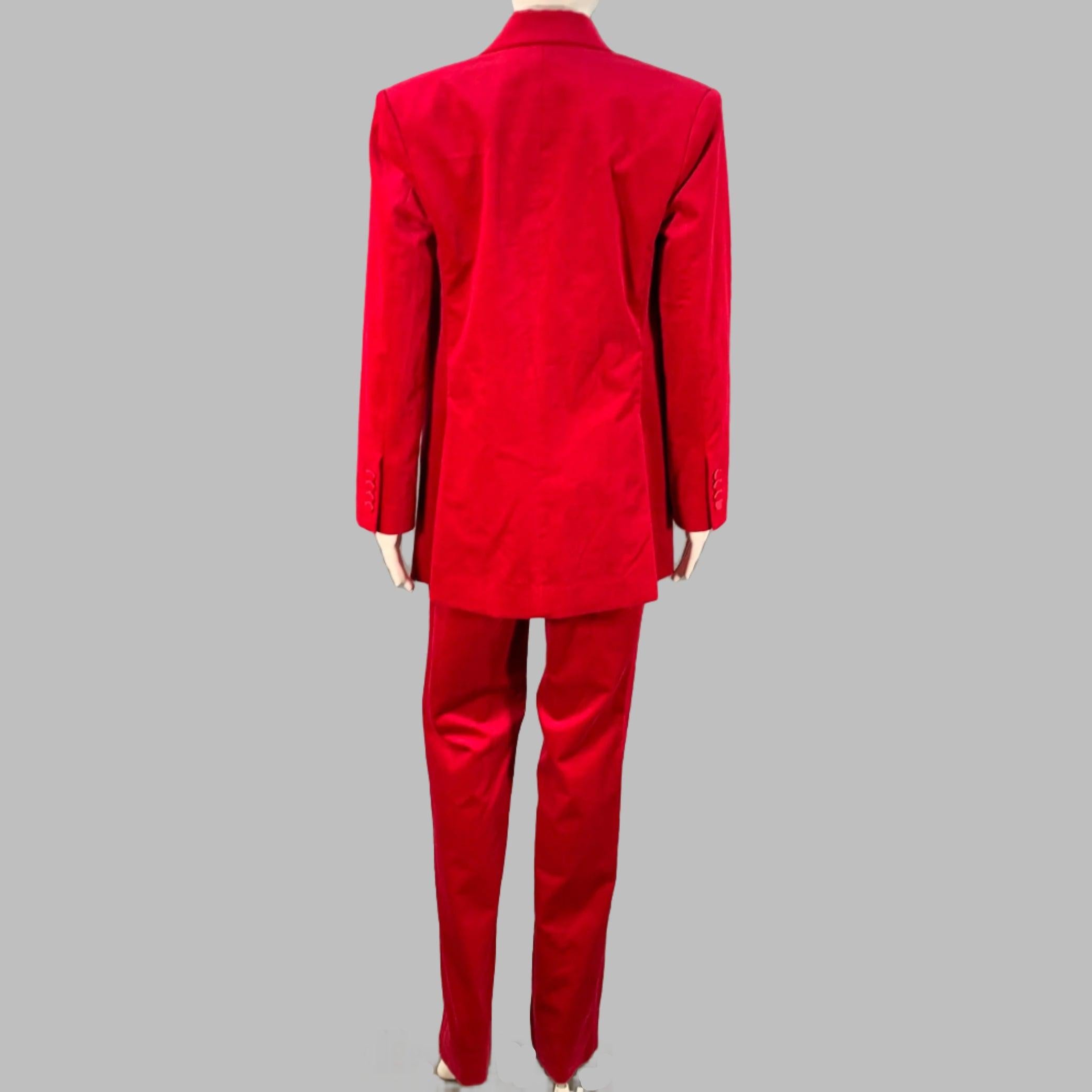 A.L.C. pantsuit in a raspberry red cotton stretch blend velvet and includes a double breasted double button peak lapel jacket and matching flat front trousers with tuxedo side stripes. Note: this garment may appear to be a true red depending on the