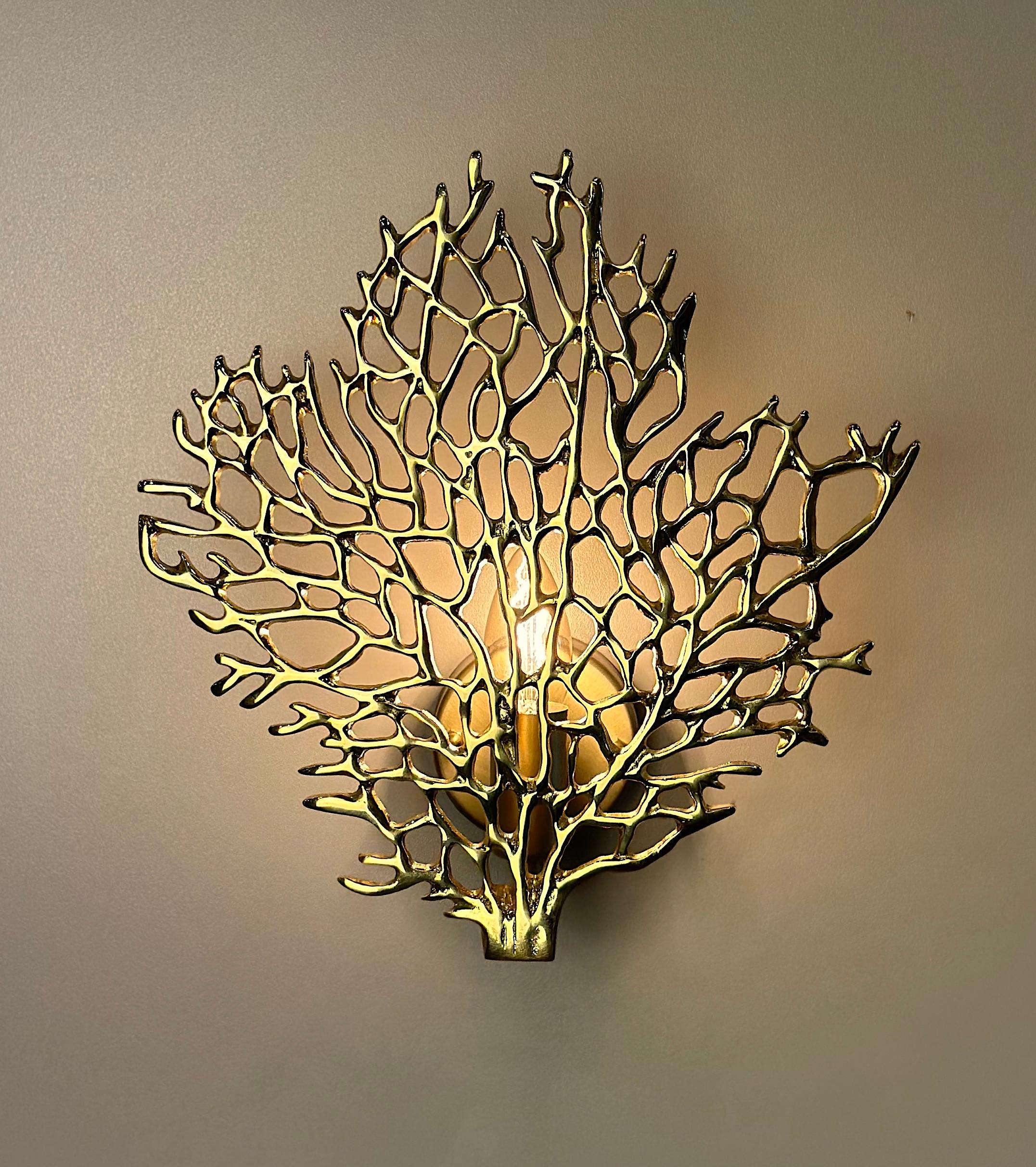 Alcamo brass wall sconce, a captivating piece of mid-century modern style lighting that combines the timeless beauty of brass with the allure of wall sconces. This stunning sconce showcases a coral reef-shaped brass casting piece that not only adds