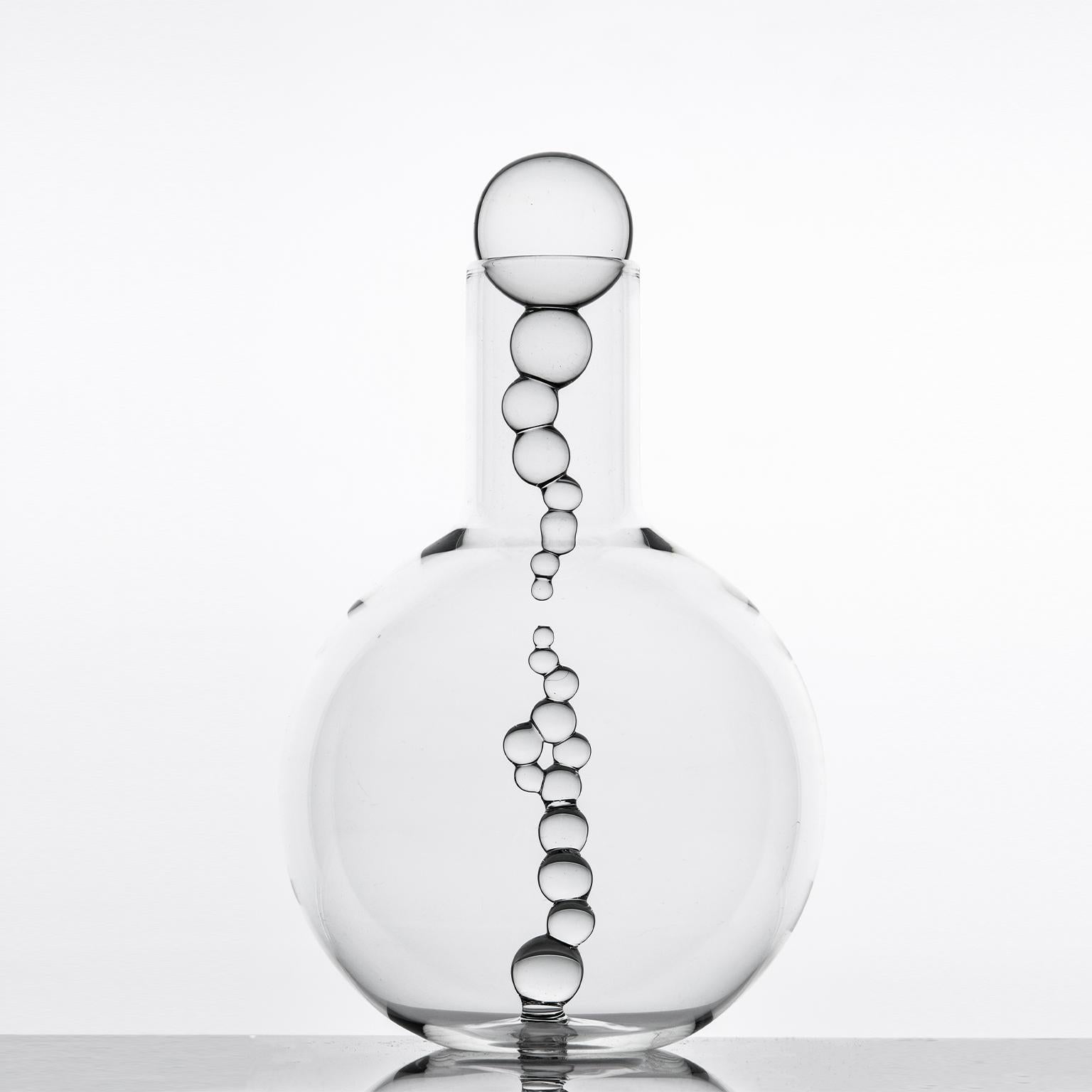 Introducing the *Alchemica Old Fashioned Set*, an exquisite trio of hand-blown glassware by the talented Simone Crestani. This sophisticated set includes six elegantly crafted old-fashioned glasses and a stylish glass bottle, perfect for enhancing