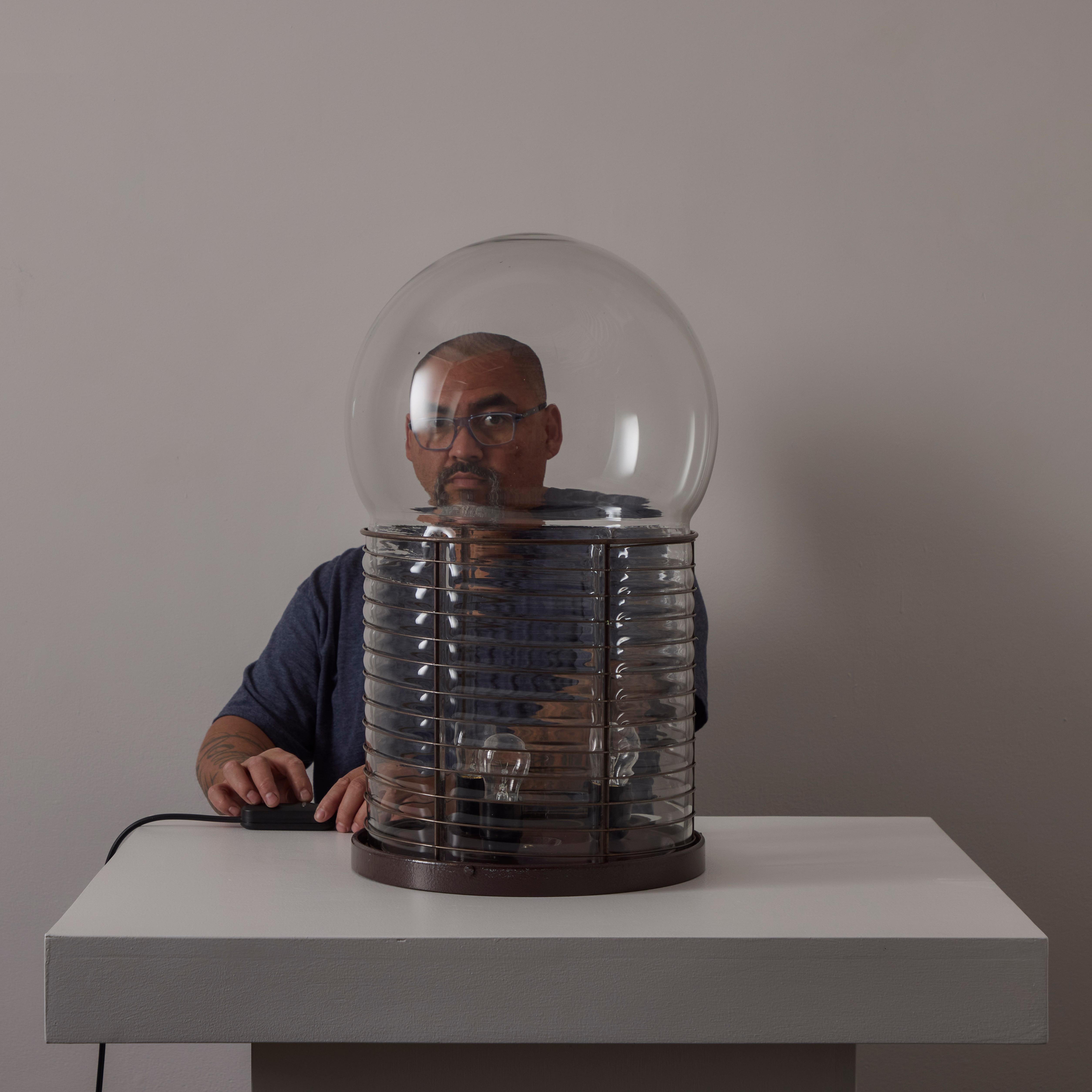 'Alcinoo' Table Lamp by Gae Aulenti for Artemide. Designed and manufactured in Italy, in 1975. Massive blown glass diffuser is the main star of the show on this piece. The glass is held within a steel cage. The light holds three E27 socket-types,