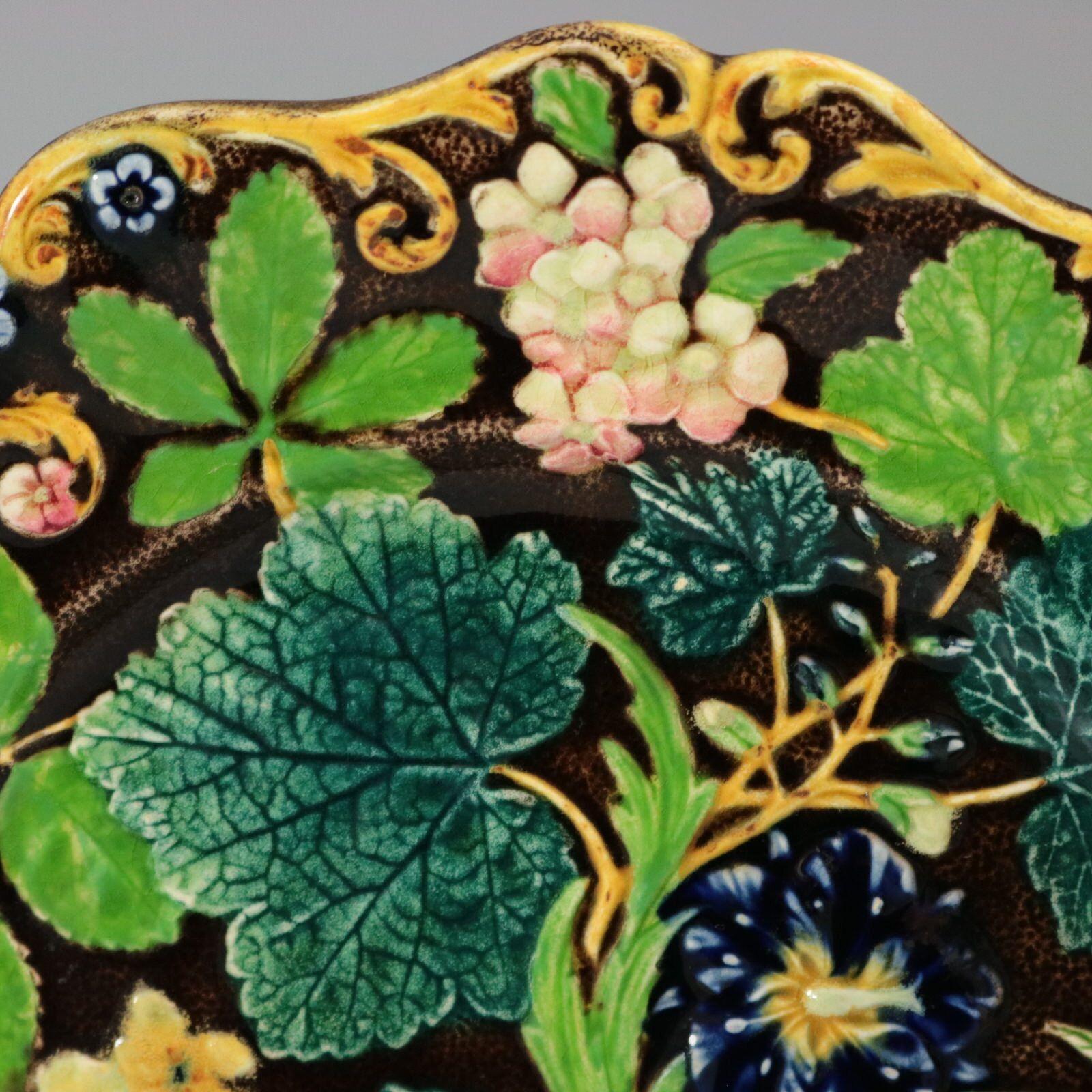 Alcock Majolica which features a stunning array of flowers and leaves. Colouration: brown, green, blue, are predominant.