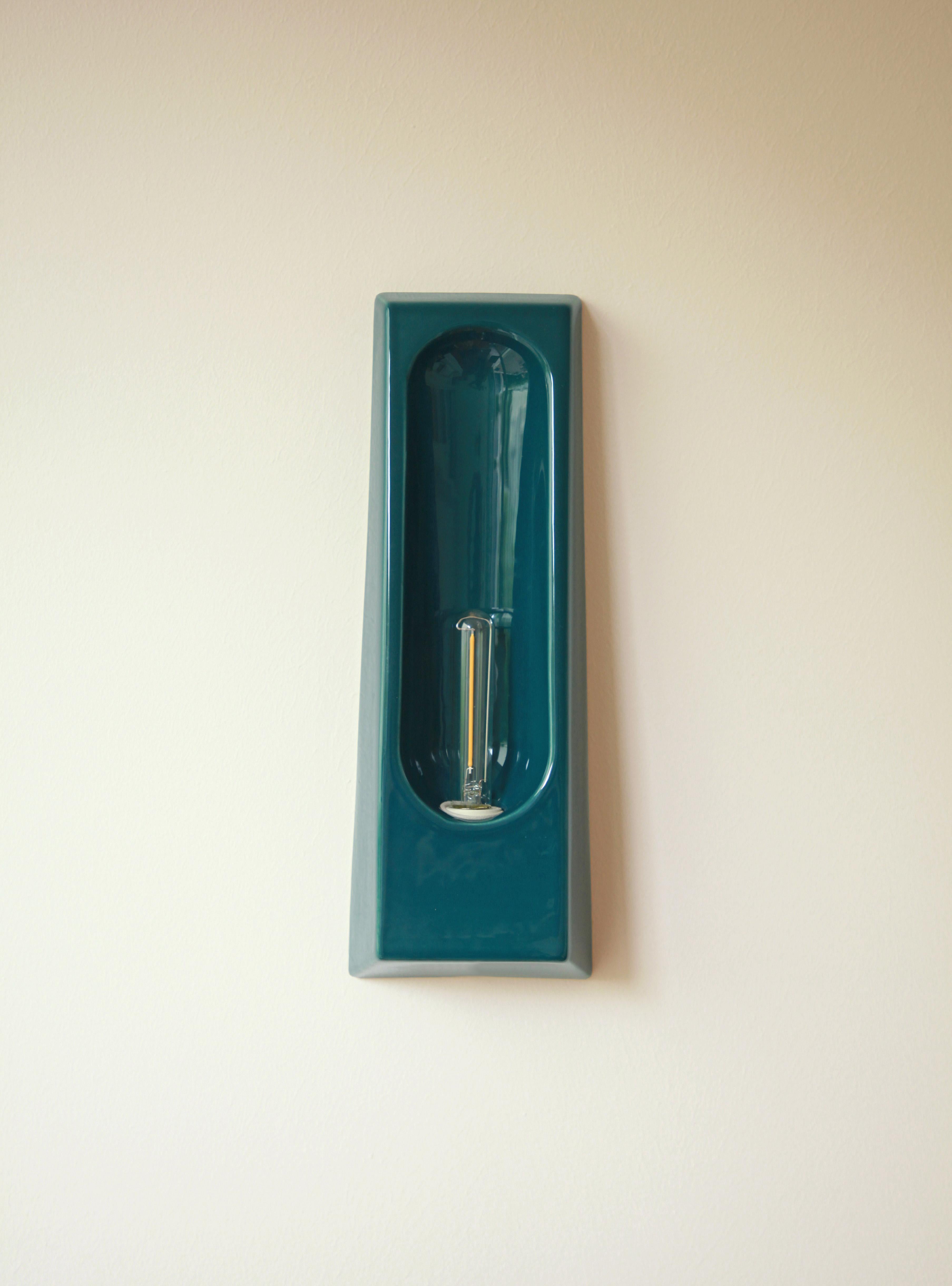 Alcove Marin Wall Lamp by Violaine d'Harcourt
Dimensions: D 7 x W 12 x H 33 cm.
Materials: Ceramic.

Wall light made in Portugal, bulb included: LED E14 1W non-dimmable. Available in different finishes. All our lamps can be wired according to each