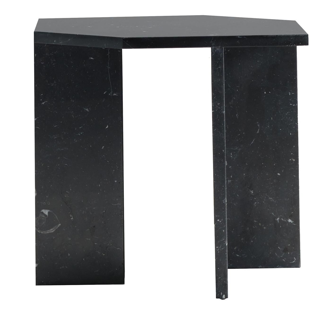 Slabs of prized glossy black Marquinia marble are the ones cleverly assembled to craft this sculptural coffee table of unmistakable geometric inspiration. Raised on angular legs somehow recalling cubes' profiles, the elongated hexagonal top