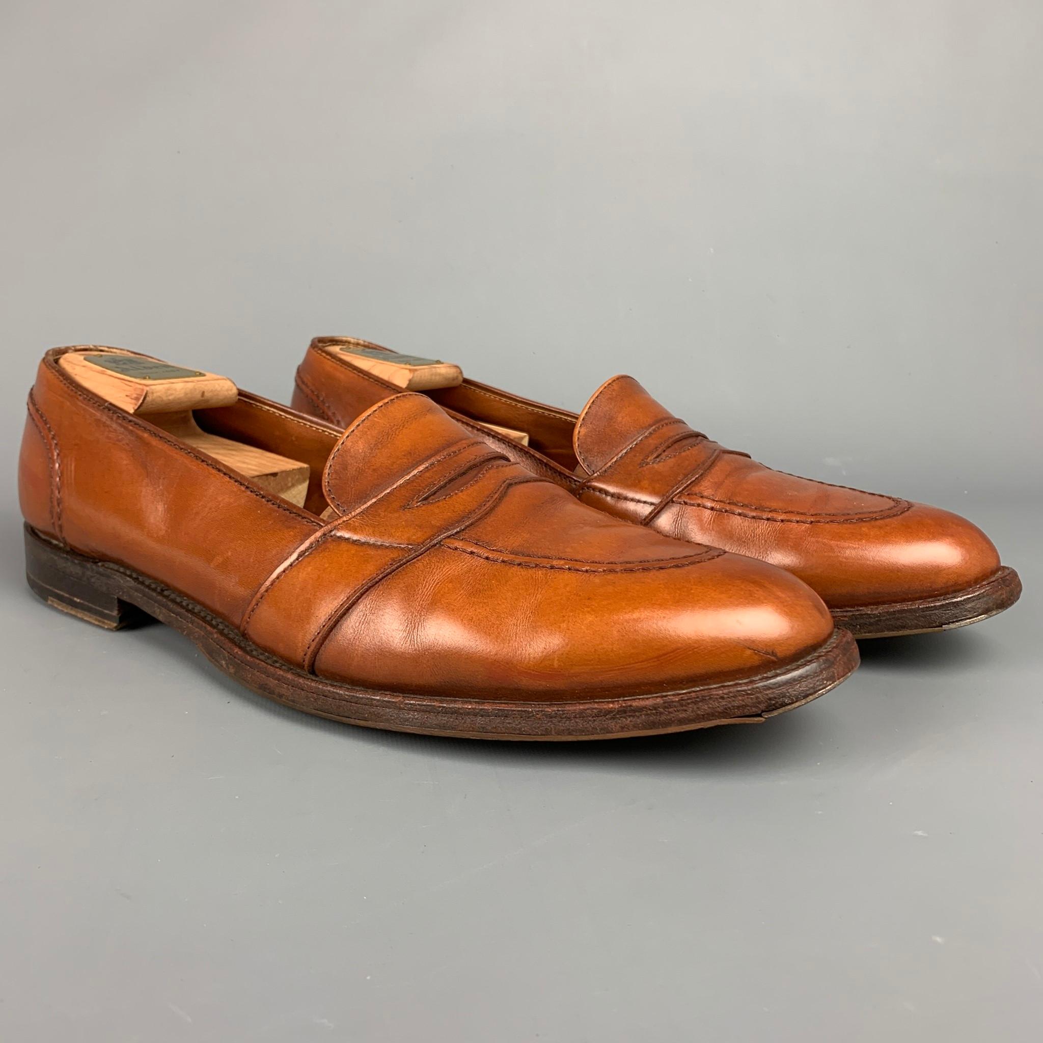 ALDEN loafers coms in a tan leather featuring a penny strap, cap toe, and a wooden sole. Comes with box and shoe tree. Made in England. 

Very Good Pre-Owned Condition.
Marked: 15 A / 685

Outsole: 13.5 in. x 4.5 in. 