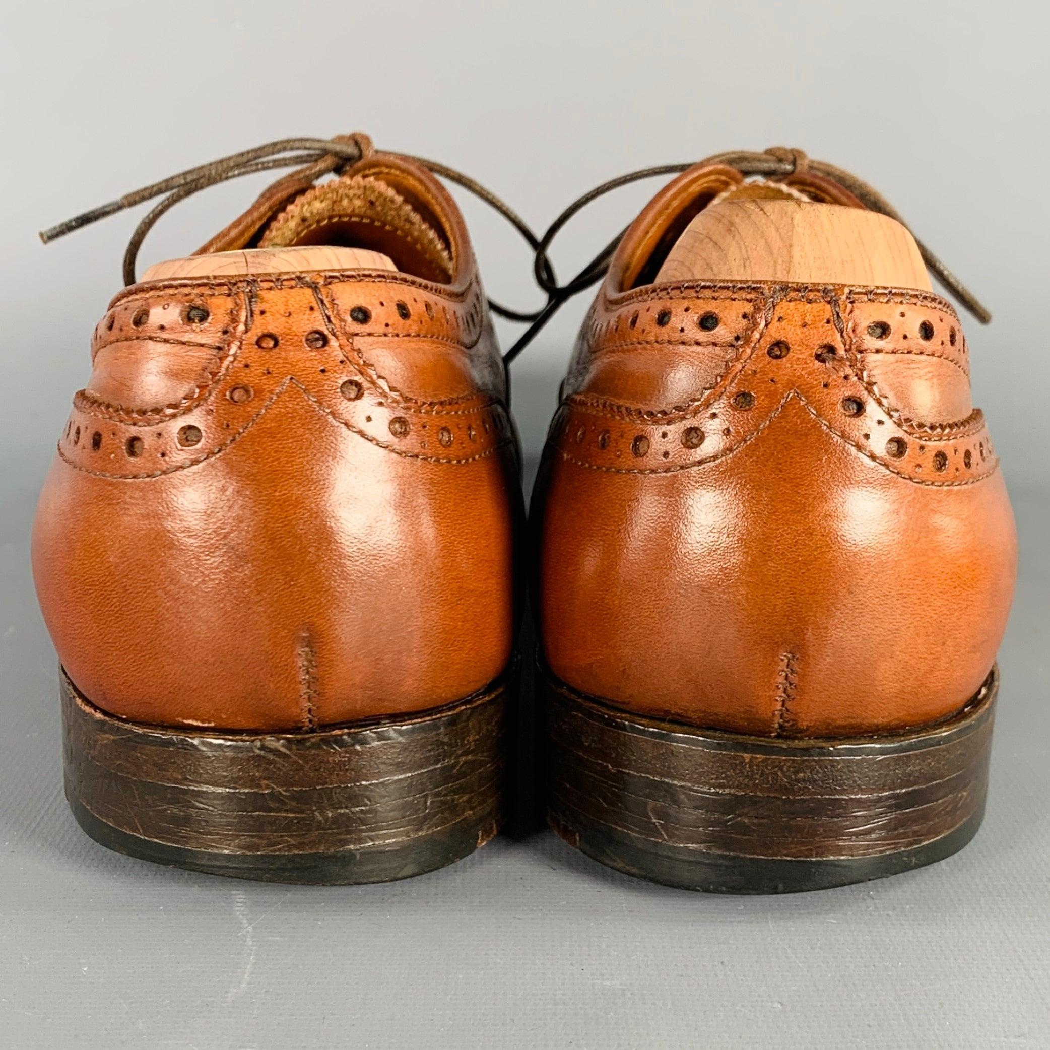 ALDEN oxford shoes
in a cognac brown leather featuring a perforated design, cap toe, and lace-up closure. Comes with brand shoe trees. Made in USA.Very Good Pre-Owned Condition. Moderate signs of wear on soles. 

Marked:   10Outsole: 12 inches  x