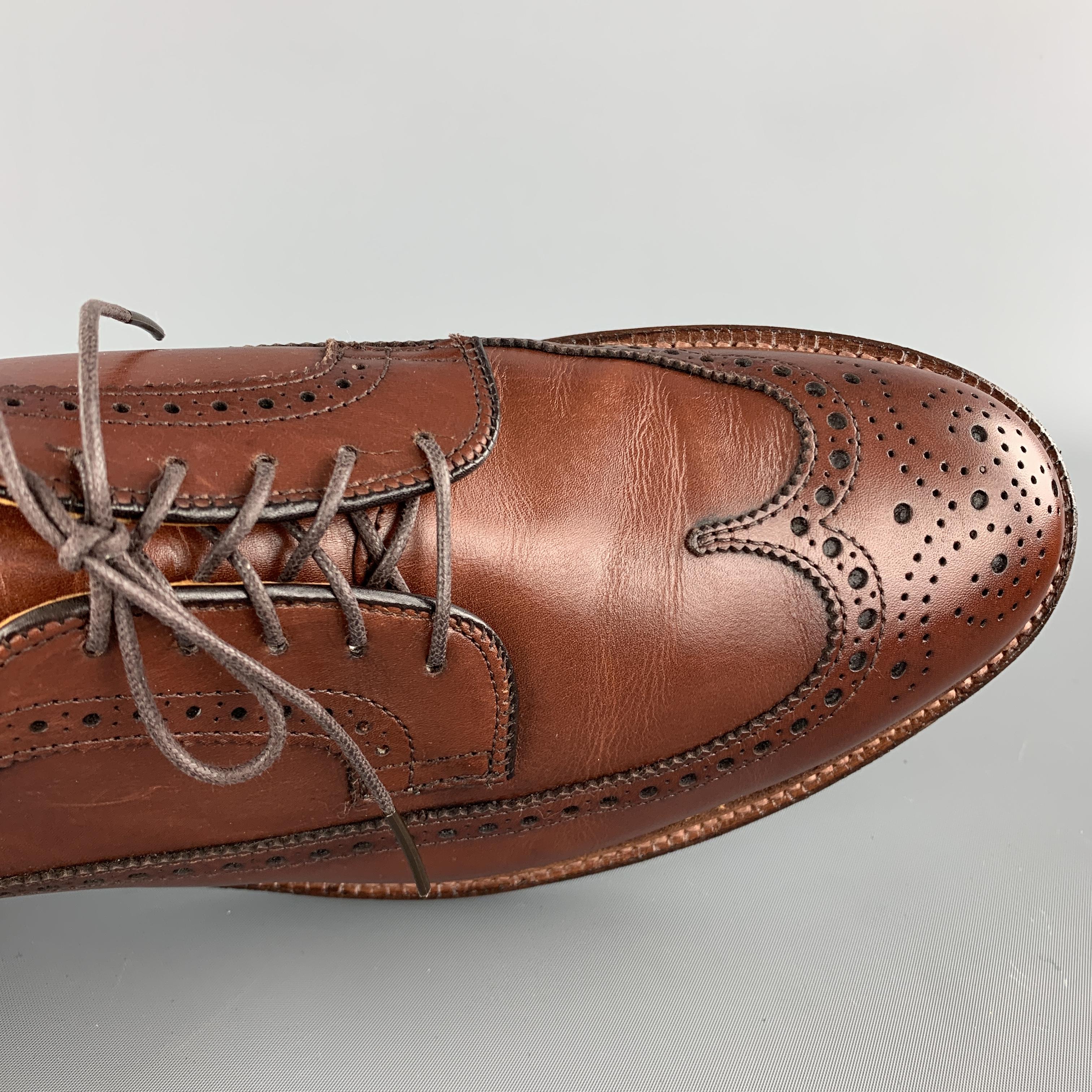 ALDEN brogue comes in tan brown leather with a wingtip and perforated trim. With box. Made in USA.

Excellent Pre-Owned Condition.
Marked: 10 1/2 D

Outsole: 12.75 x 4.5 in.