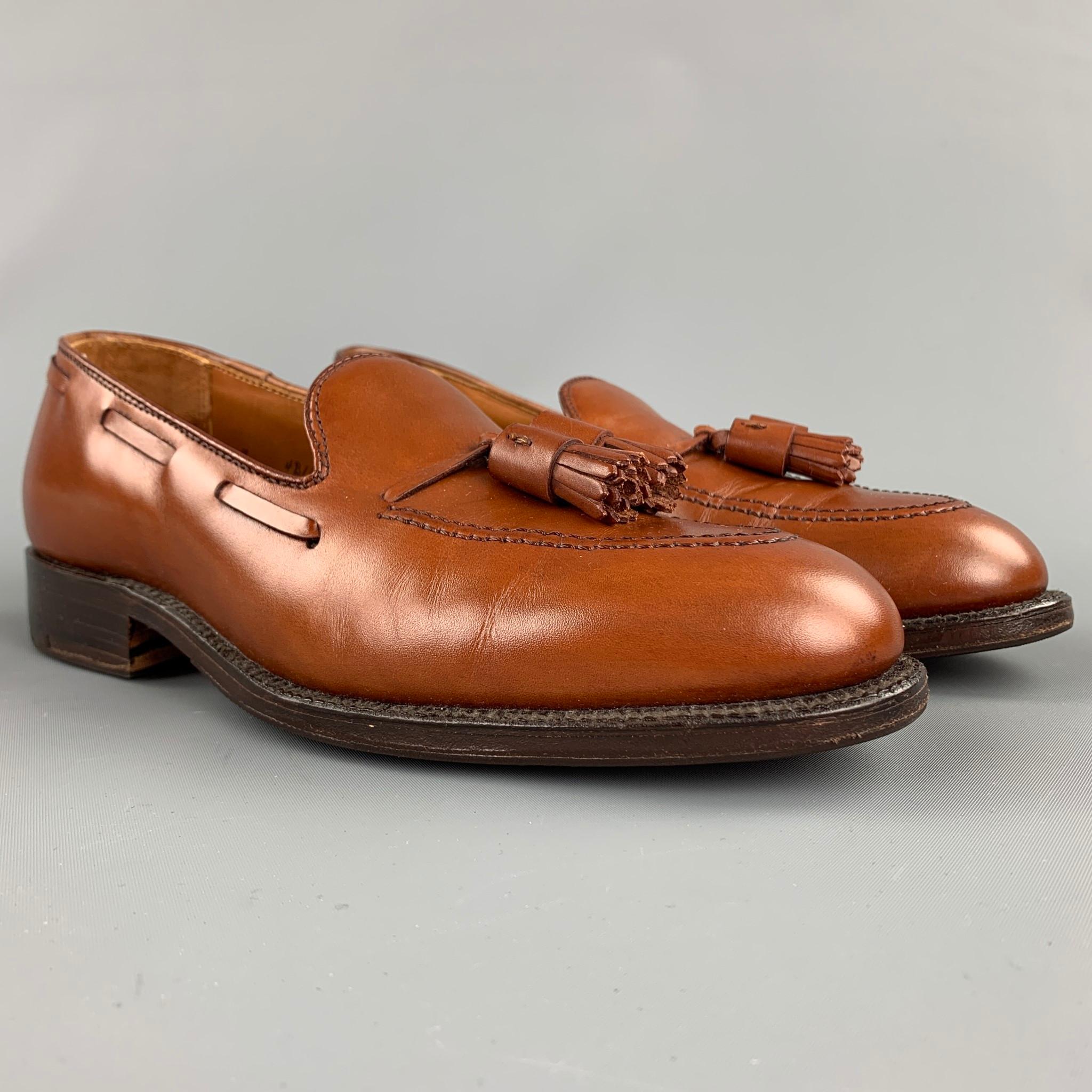 ALDEN loafers comes in a Burnished tan calf leather featuring front tassels, leather insole, top stitching, and a wooden sole. Made in USA.

New With Box. Pre-Owned Condition.
Marked: 7 D 662

Outsole: 11 in. x 4 in. 