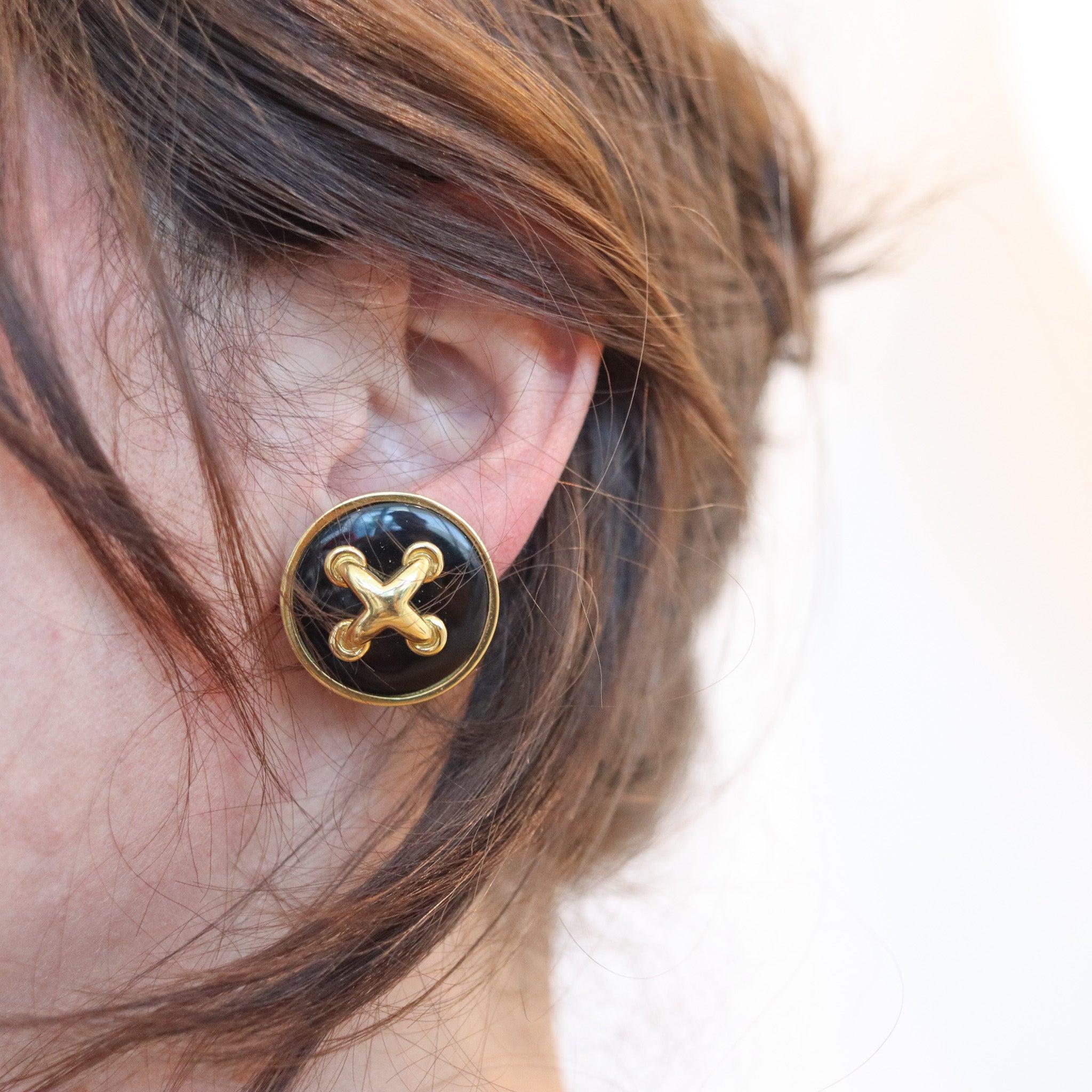 Pair of ear-clips designed by Aldo Cipullo (1936-1984) for Cartier.

These are an elegant pair of clips-on earrings created in New York City by the jewelry designer Aldo Cipullo, back in 1970. The button’s shaped earrings have been carefully crafted