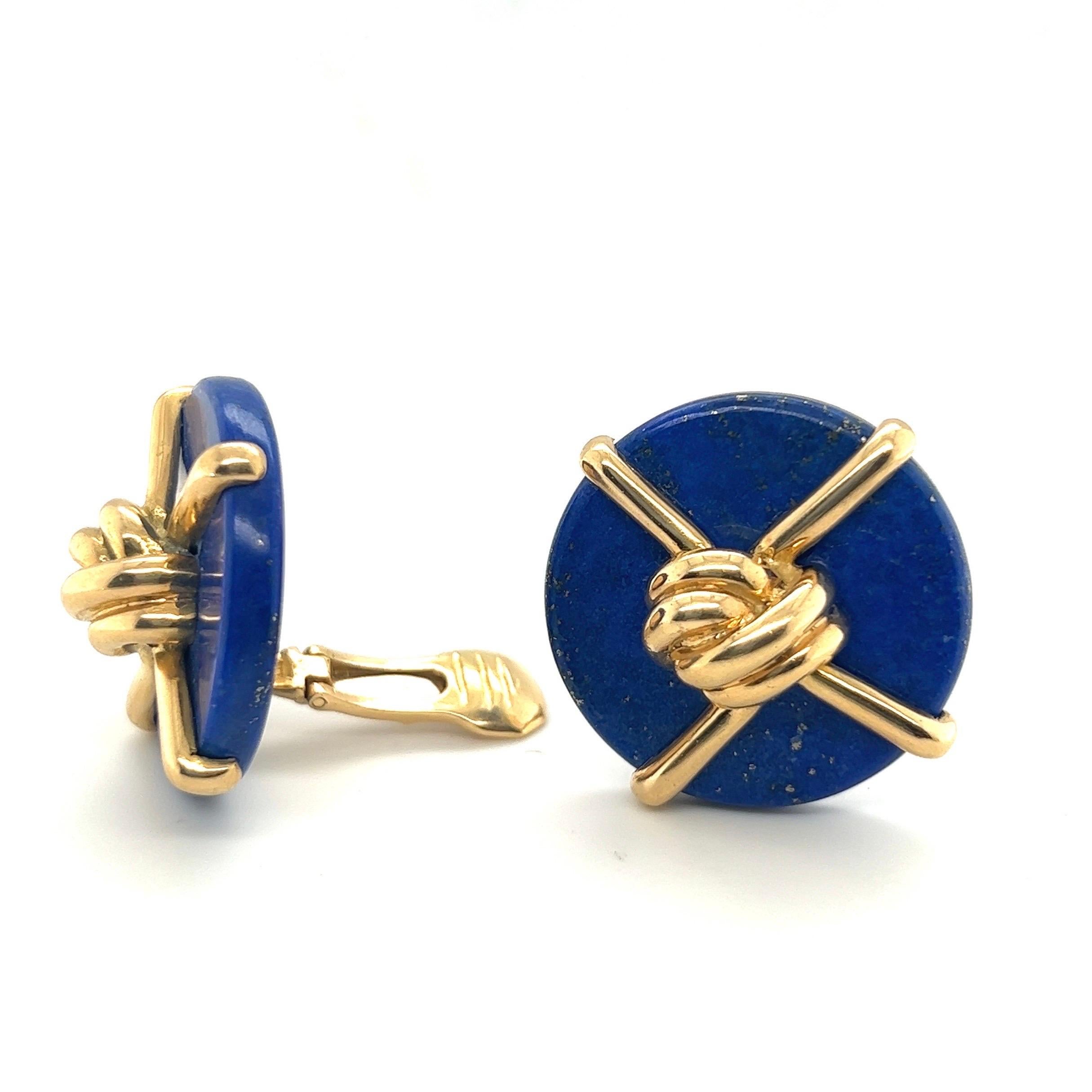 Iconic 18 karat gold lapis lazuli earrings designed by Aldo Cipullo for Cartier in 1973.
Geometrically designed ear clips each composed of a deep blue lapis lazuli disc, the front decorated with polished 18 karat yellow gold wire centering upon a