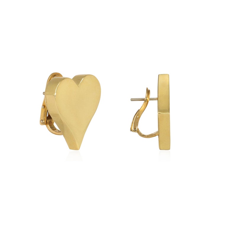 A pair of gold earrings designed as a playing card suit of a heart and a diamond, in 18k with posts and clip backs.  Aldo Cipullo for Cartier 