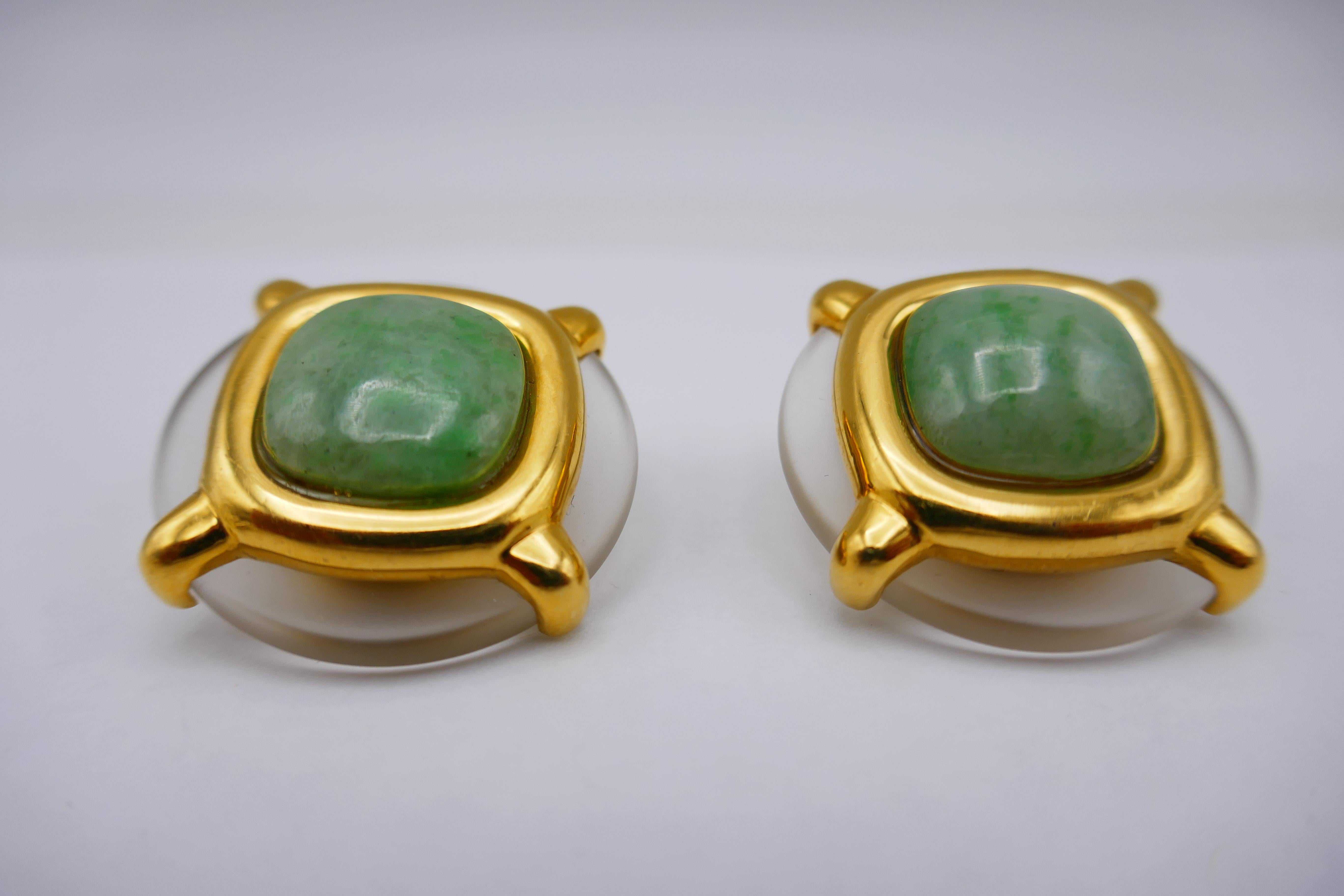 An amazing pair of vintage (1974) clip-on earrings by Aldo Cipullo for Cartier. Made of 18k yellow gold, frosted rock crystal and cushion-shaped cabochon jade. Stamped with Cipullo and Cartier maker's marks, a year of production (1974) and a