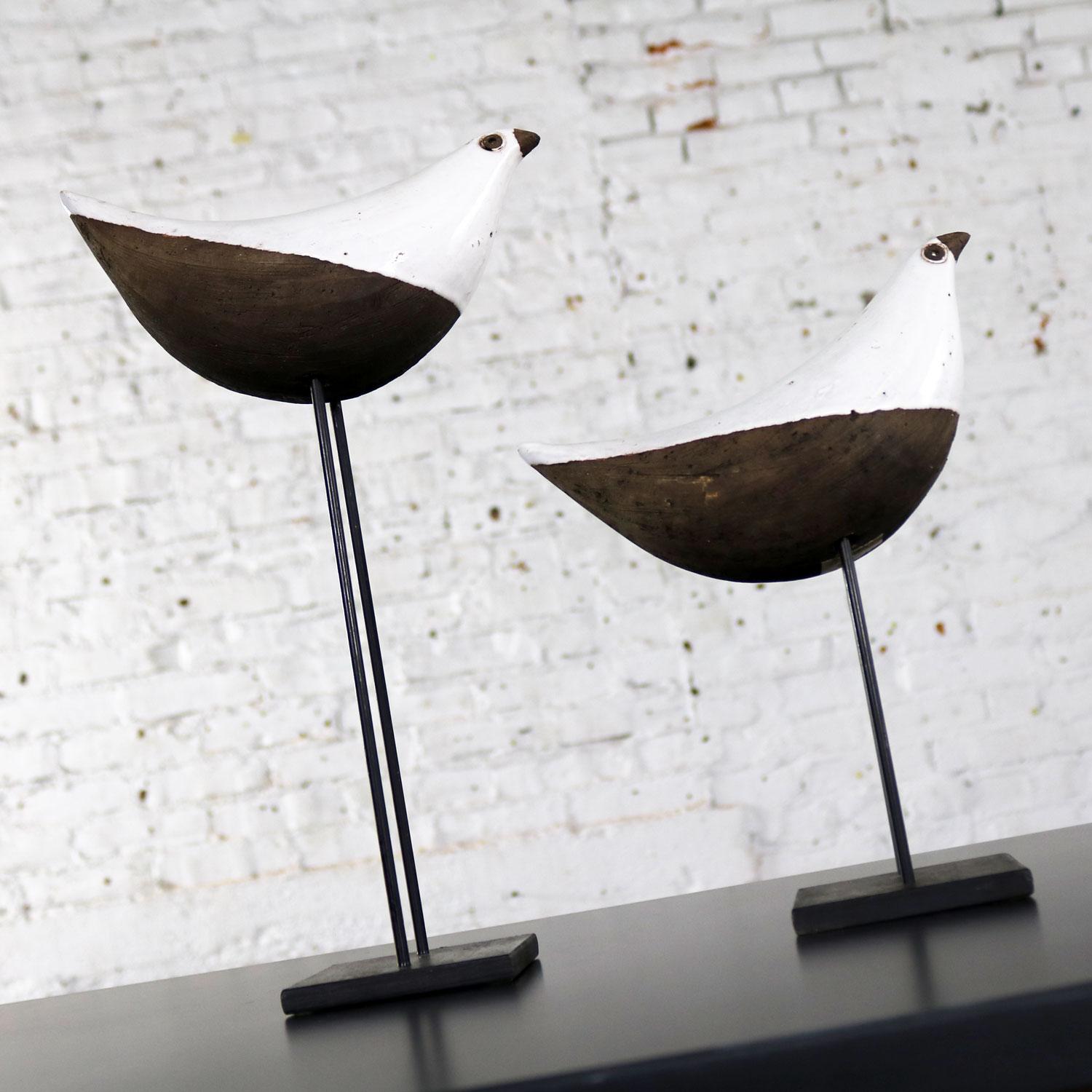 Handsome pair of Aldo Londi designed ceramic sculptures of a bird or dove on a metal stand in white and dark brown glaze on red clay. This classic Mid-Century Modern pair is produced by Bitossi of Italy for US importer Rosenthal-Netter. They are in