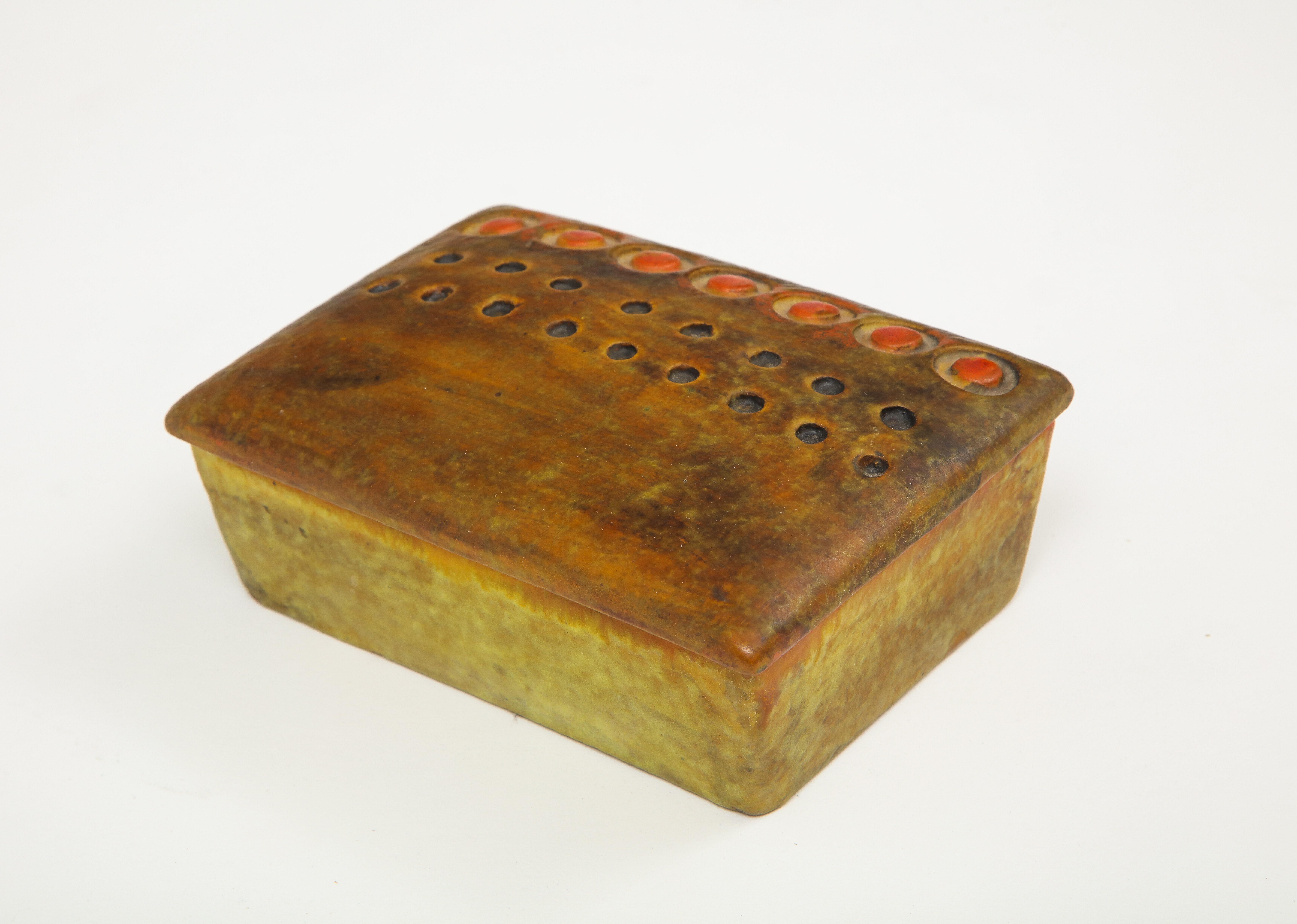 Italian midcentury ceramic box in matte finish orange and ochre glaze by Aldo Londi for Bitossi. Box lid has decorative raised pattern.