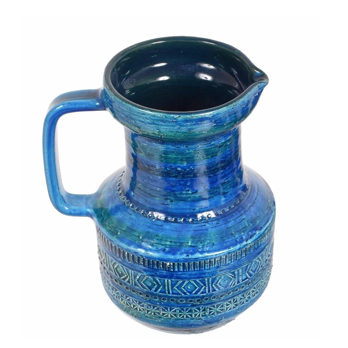 Set of blue enameled blue glazed ceramic carafe and glasses by Aldo Londi of Rimini and produced by Bitossi. Handmade in Italy with a hand carved geometric design and in satin turquoise and vibrant cobalt blue, Italy, 1950s-1960s.
A carafe and six