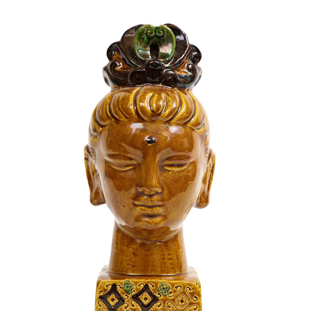 Aldo Londi Bitossi Kwan Yin Buddha, Ceramic, Caramel Brown, Paisley. Beautiful and soothing Kwan Yin bust glazed in caramel brown with a hint of green in her tiara. Her plinth base is glazed in butterscotch and decorated with psychedelic paisley and