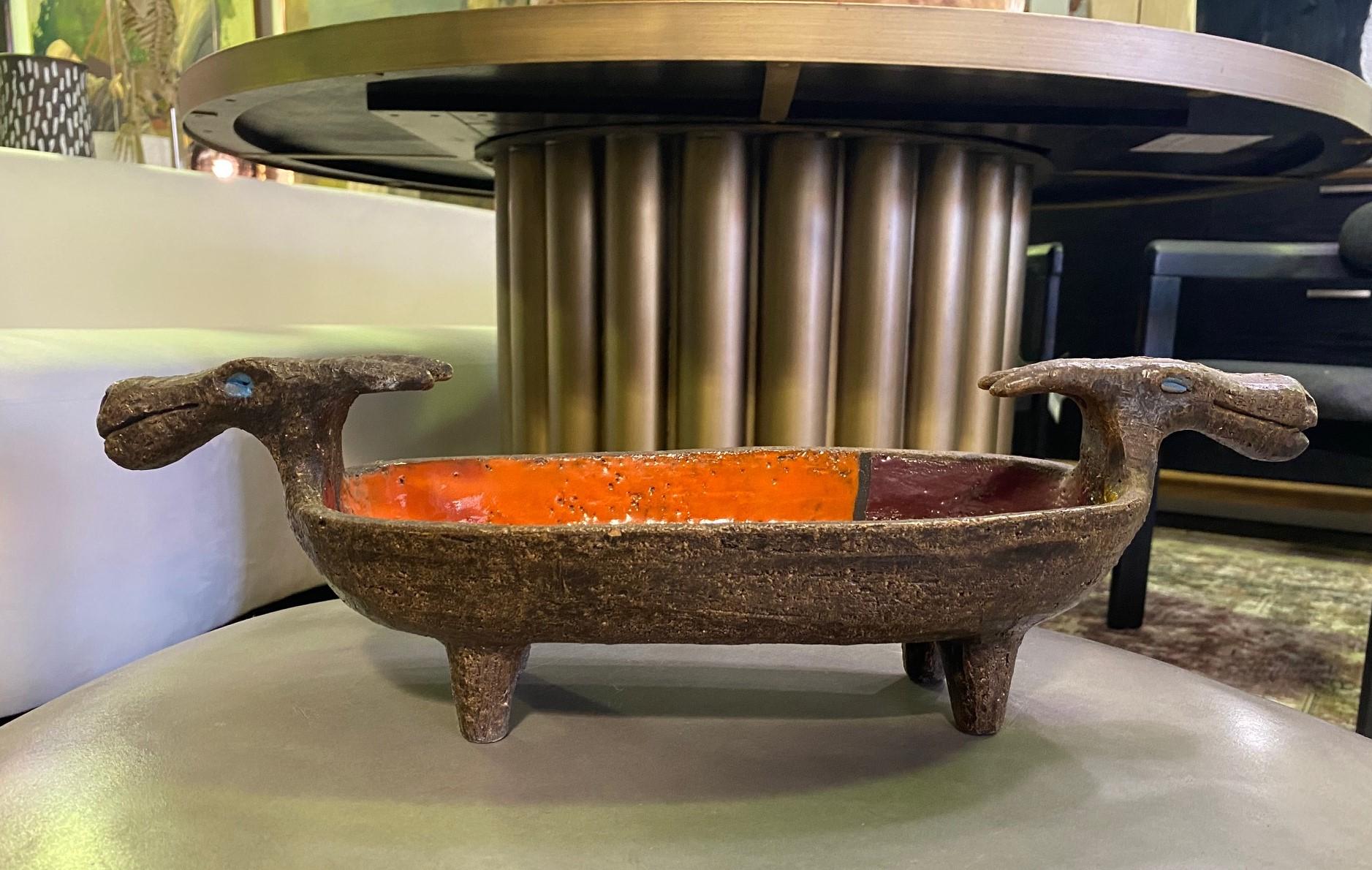 A very rare and scarce, exquisite large pottery bowl from Italian designer Aldo Londi for Bitossi, Italy. This piece features a dragon's head on each end. 

The bowl is impeccable and displays the vibrantly colored Mondrian design glazed interior.