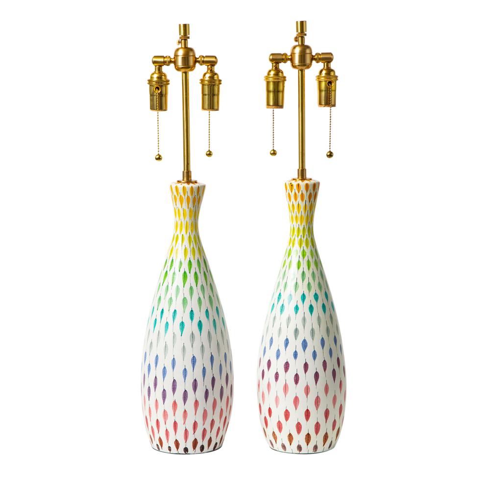 Aldo Londi Bitossi table lamps, ceramic, multi-color, piume, signed. Pair of medium scale tapered bottle form table lamps decorated with a piume (feather) pattern. The colors range from top to bottom: orange, yellow, green, teal blue, gray, royal