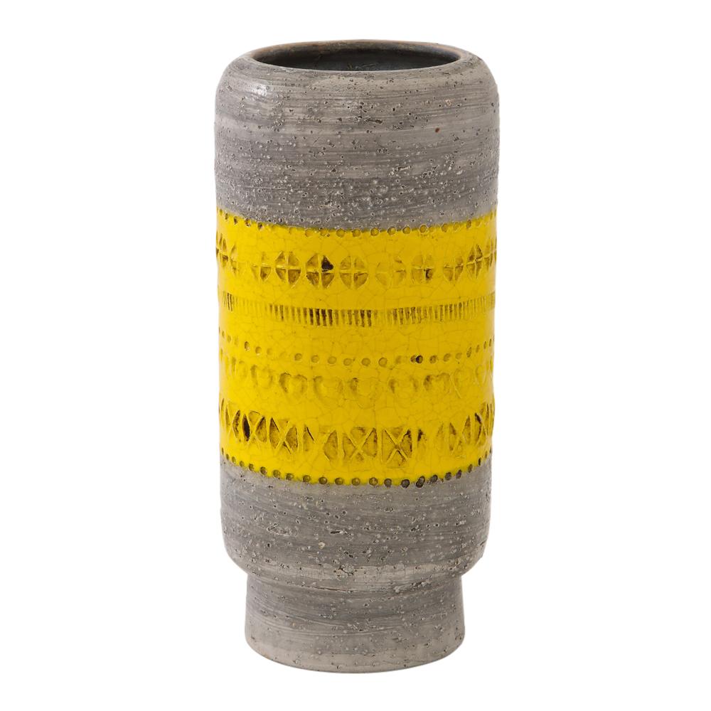 Bitossi vase, ceramic, gray and yellow, signed. Medium scale rounded cylinder vase with footed base. The belly of the vase is glazed in a canary yellow and decorated with hand tooled impressed geometric patterns over a washed gray. Marked 