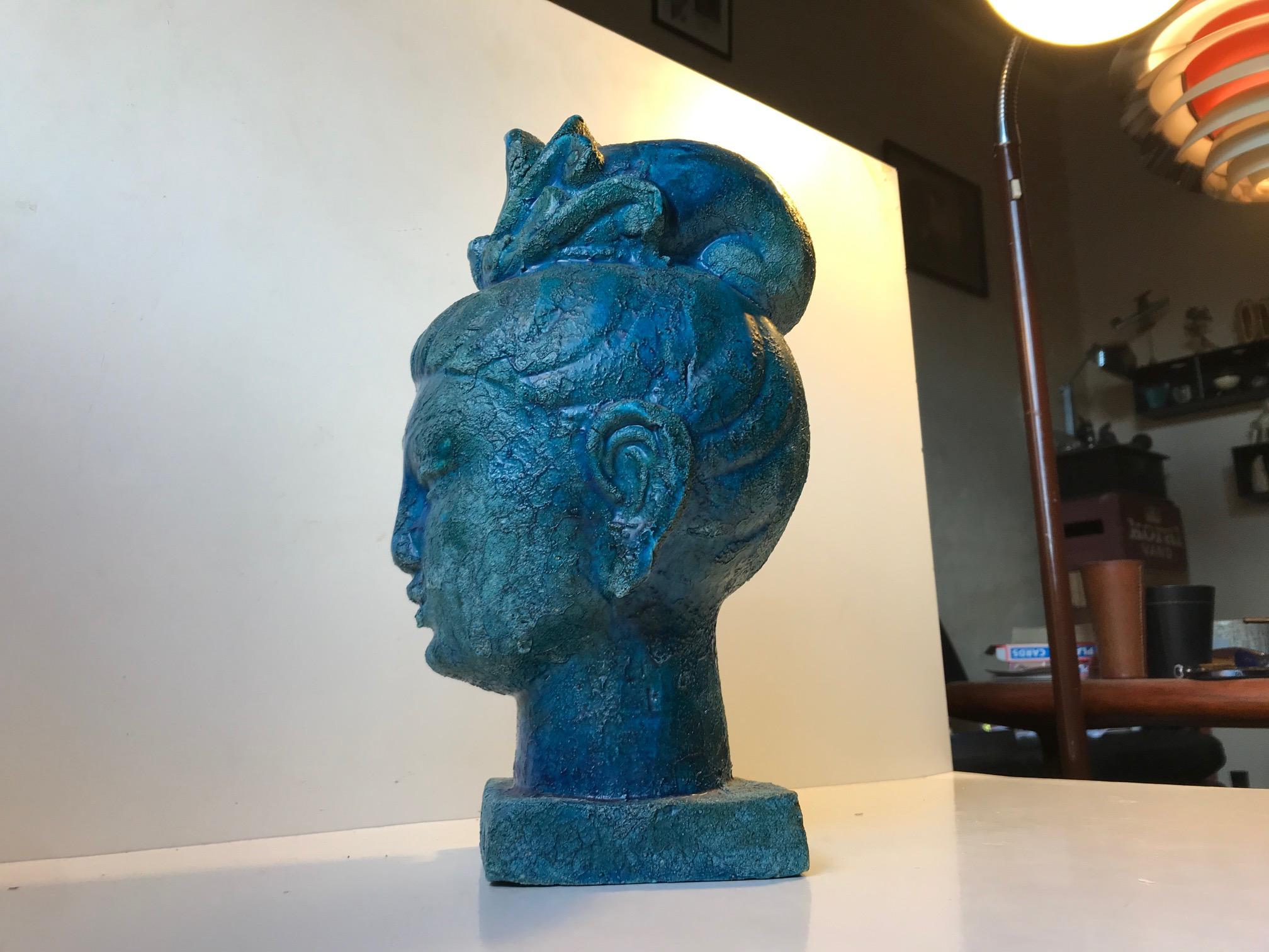 Aldo Londi Buddha head in the blue/turquoise 'Cinese' (Chinese) glaze, mimicking ancient bronzes that has been resting on the ocean floor for millennia. This is number 47 of 104 made. It was manufactured by Bitossi in Italy in the late 1960s. This