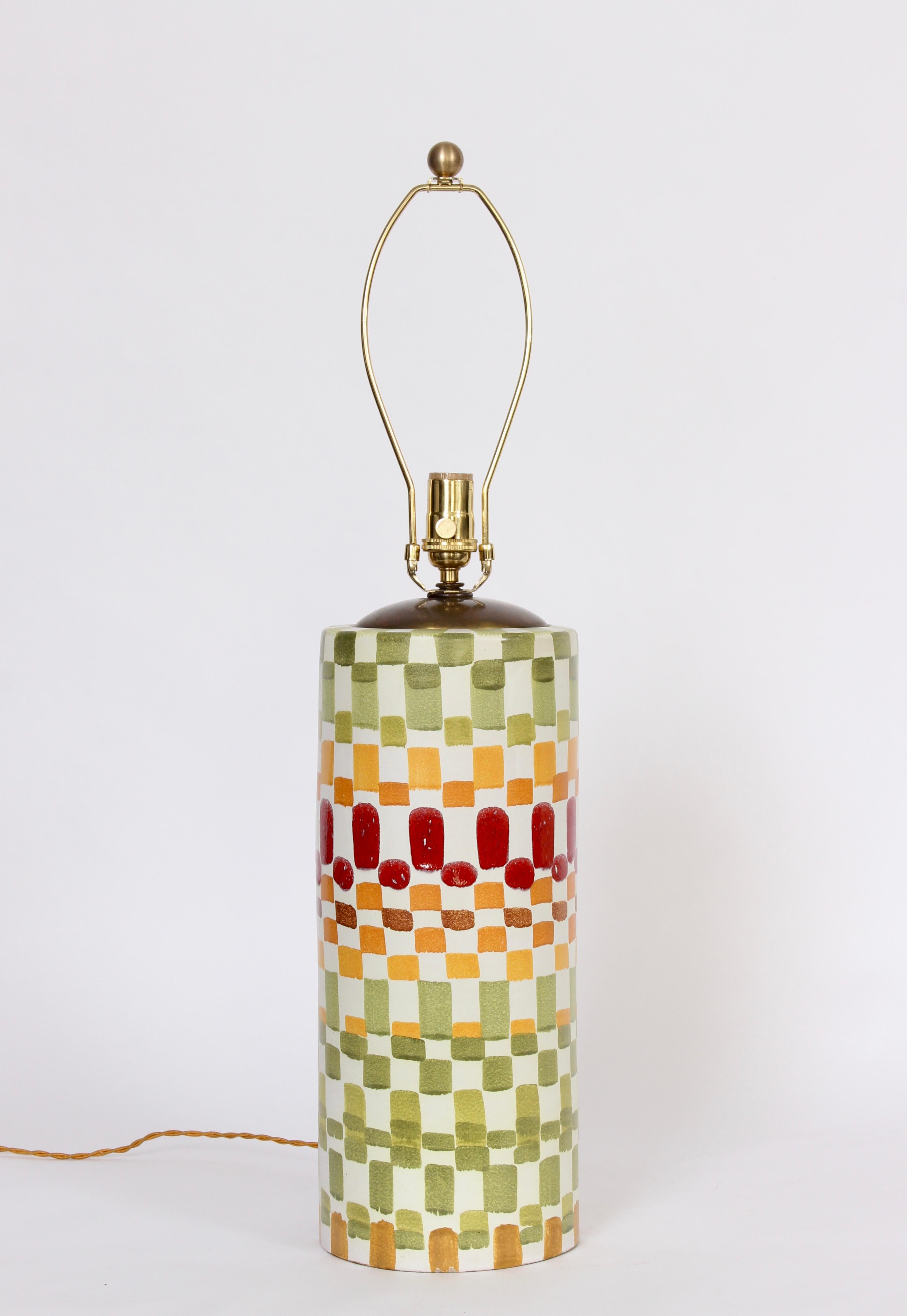 Aldo Londi for Bitossi hand painted multi colored checkerboard glazed ceramic table lamp, 1960's. Featuring a reflective glazed white column, with a patchwork like, repetitive square pattern in greens, gold red and orange. Shade shown for display