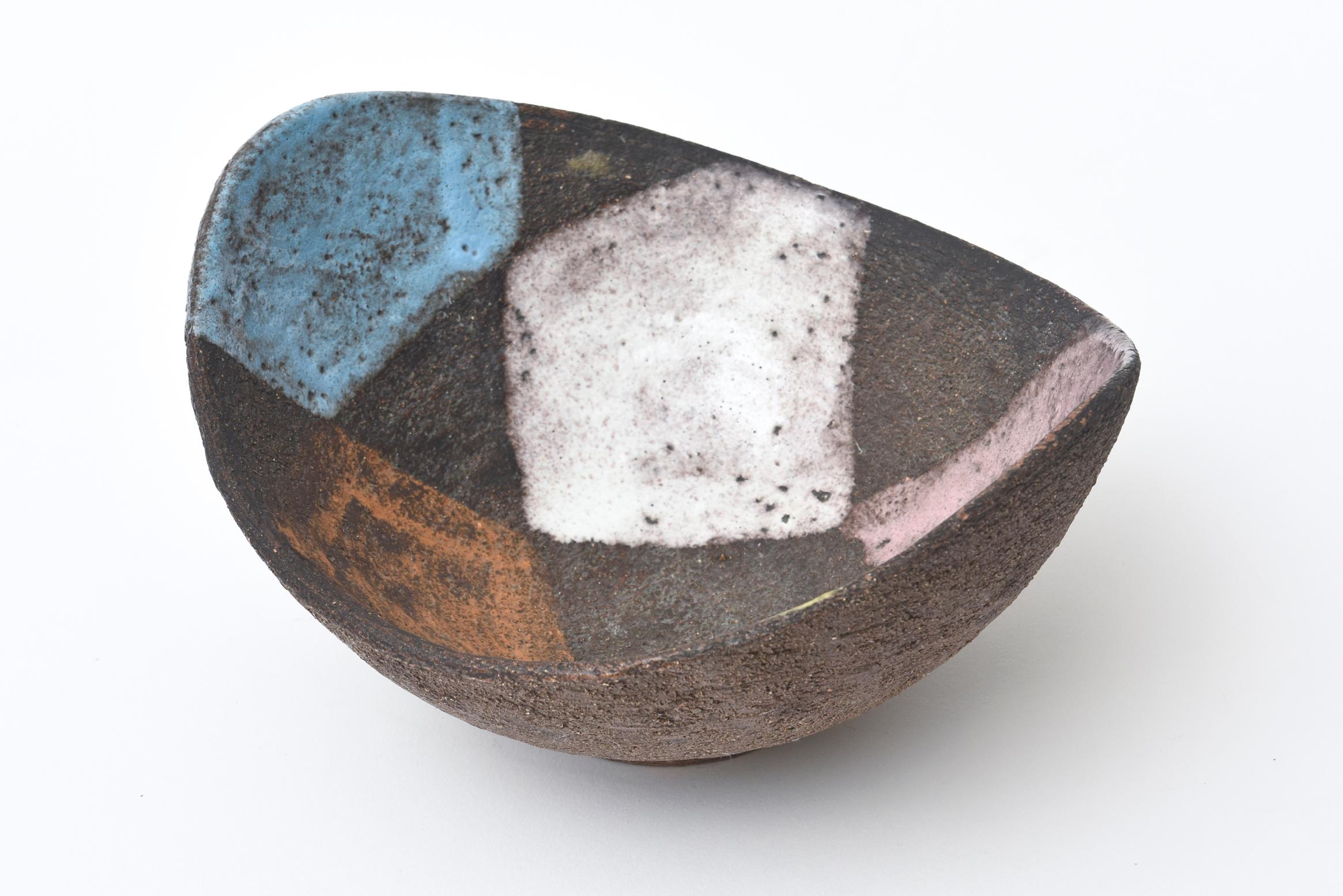 This wonderful earthy organic modern vintage Aldo Londi for Bitossi Glazed patchwork ceramic bowl is Italian and Mid-Century Modern. The brown ceramic looks like stone. It is also in the style of Guido Gambone. The splatter of patchwork colors are