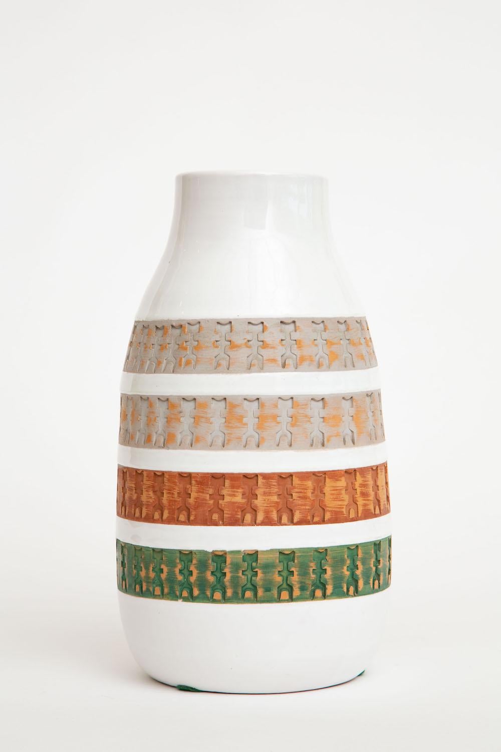 This special and hard to come by Italian Aldo Londi for Raymor Bitossi ceramic vase or vessel is vintage. It has 4 bands of incised etched textural Mayan style abstract inspired tribal designs and stick figures in varying bands of color. The rich