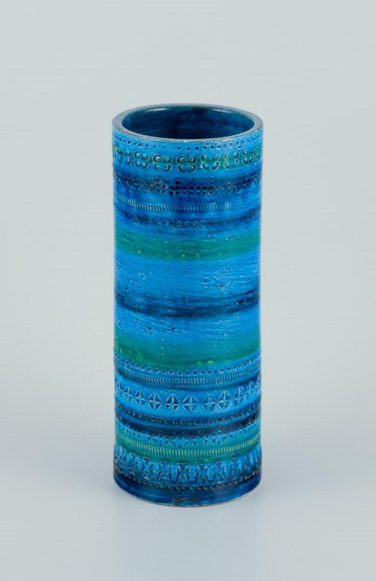 Aldo Londi (1911-2003) for Bitossi, Italy. 
Large cylindrical ceramic vase. Glazed in green and blue tones with a geometric pattern.
Approximately 1970.
Marked.
In excellent condition with a minor chip on the top of the vase.
Dimensions: Height 30.4