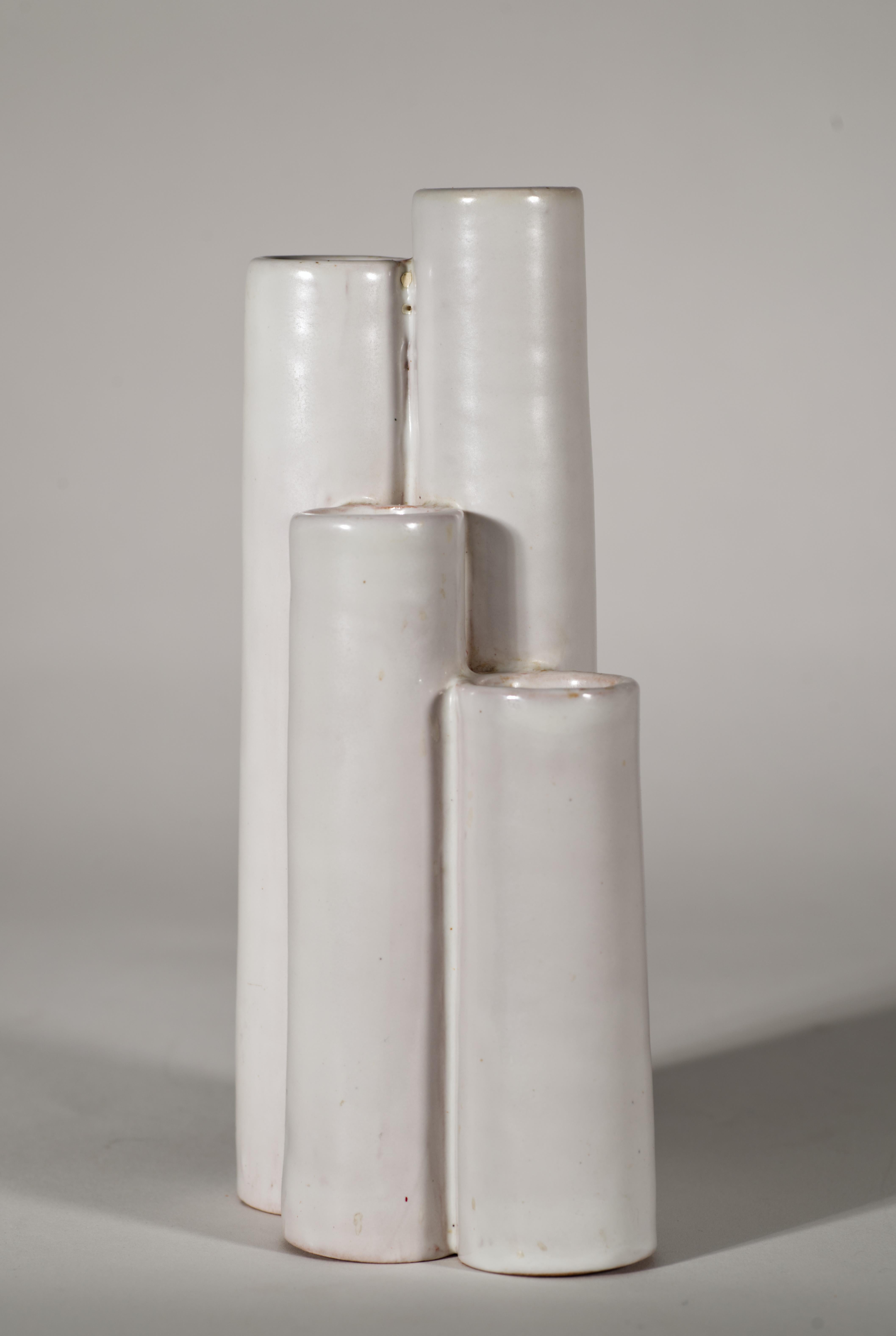  Modernist majolica bud vase features a complex sculptural shape with 5 stepped cylinders; minimal form of the piece is accentuated by the monochromatic white glaze. The vase is reminiscent of the Arkitectura series, developed by Londi from 1955 to
