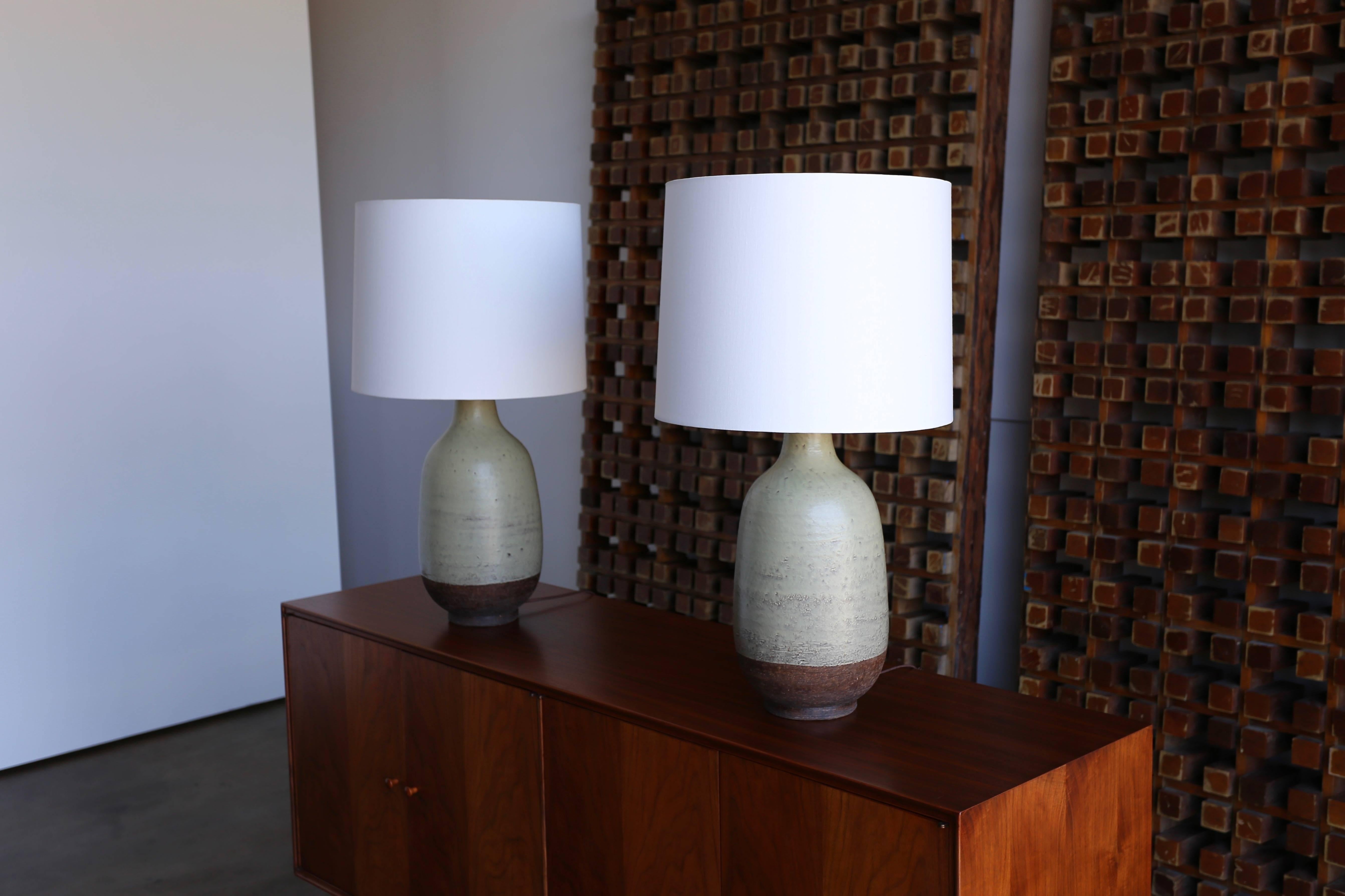Aldo Londi for Bitossi pair of ceramic lamps. This pair has been professionally rewired and fitted with new custom linen shades. The listed measurements include the shades.
 