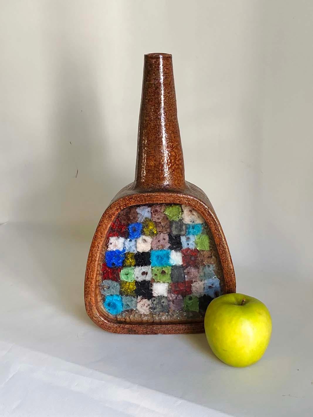 Here's a very desirable and hard-to-find vase by Aldo Lodi for Bitossi. From the Fritte series, this example features a wonderful multi-colored mosaic fused glass pattern.

The chunky bottle form measures 14.25